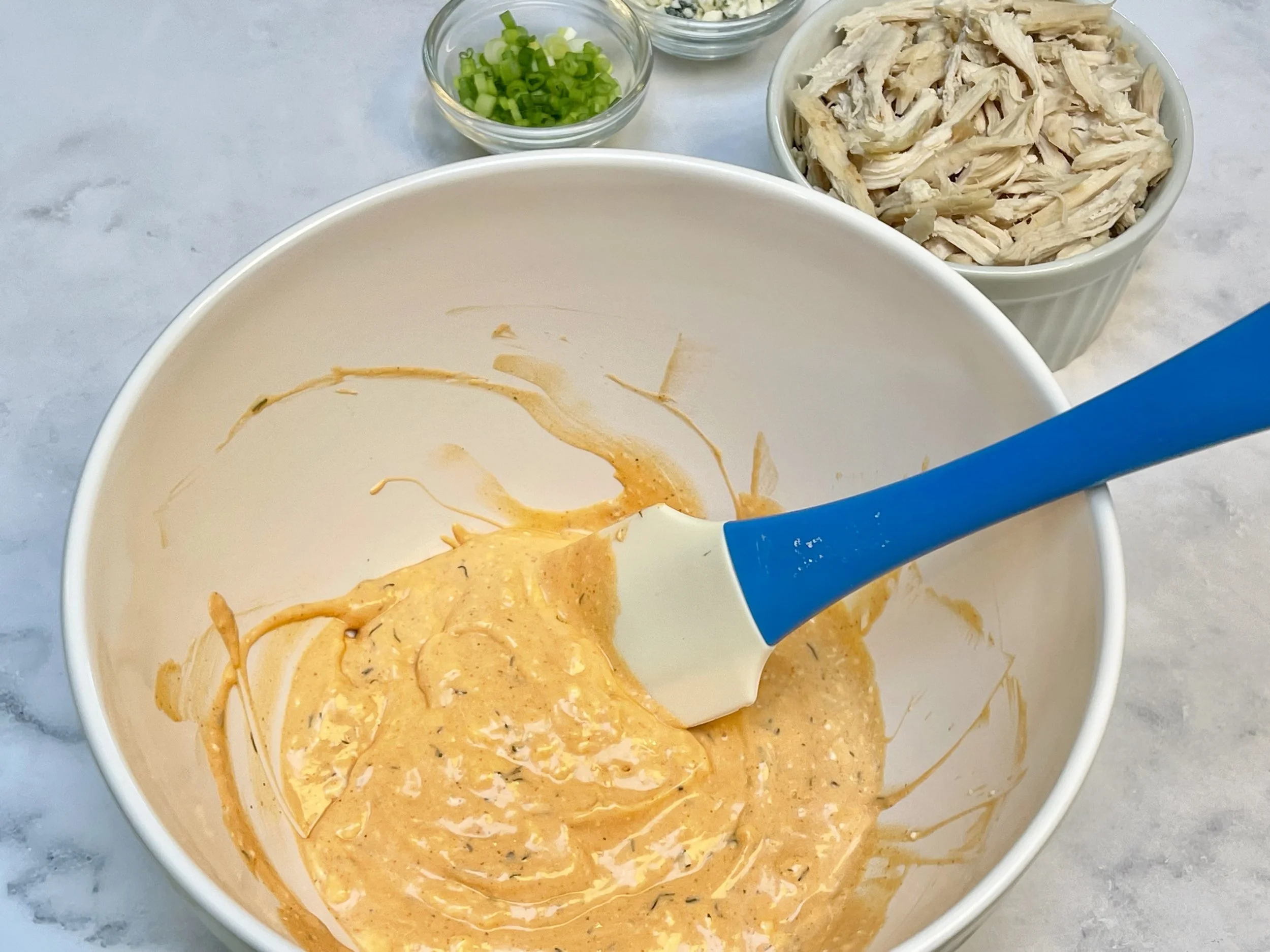 Mixing the wet ingredients for Buffalo Chicken Dip
