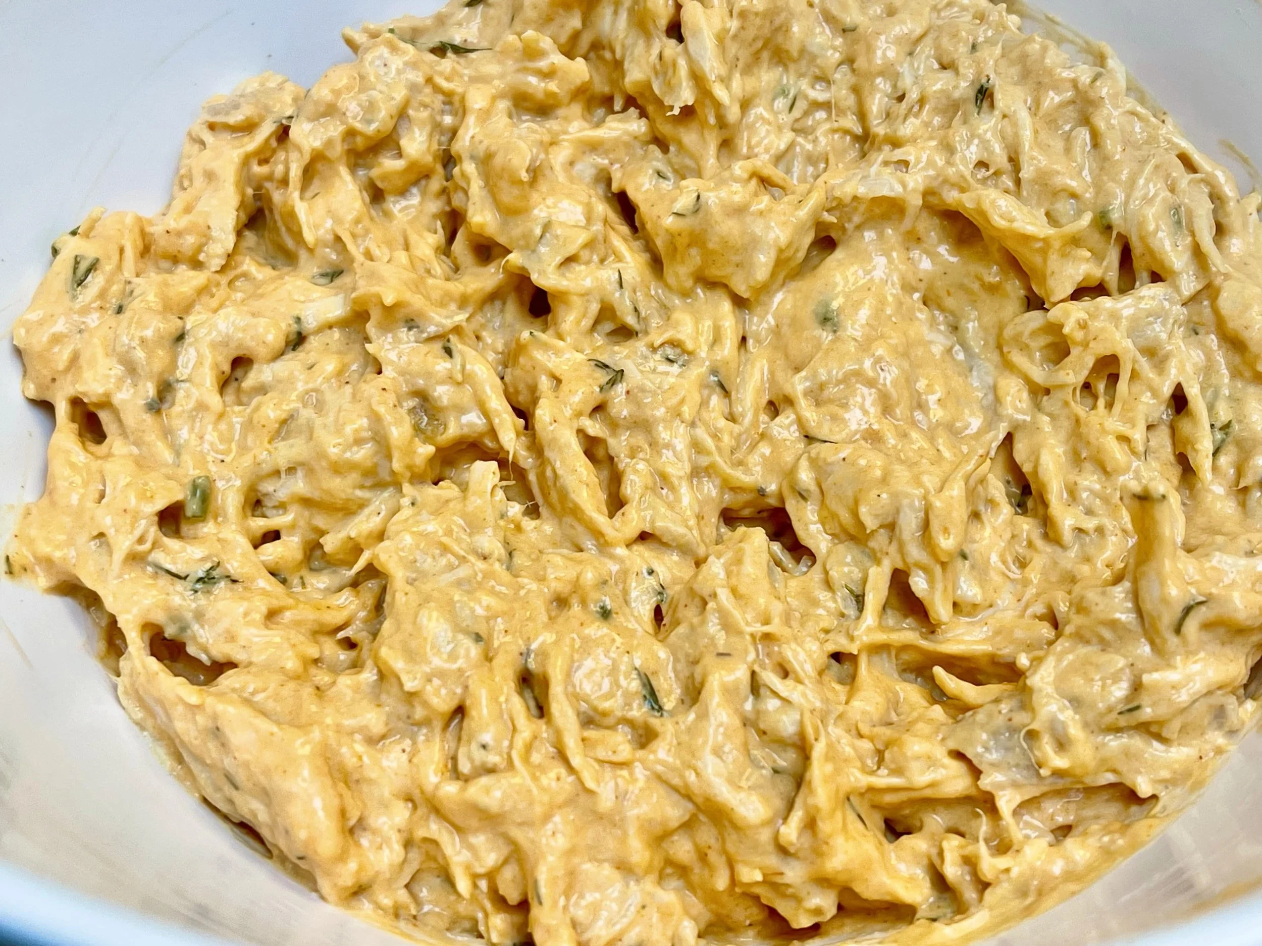 Adding the chicken to the dip