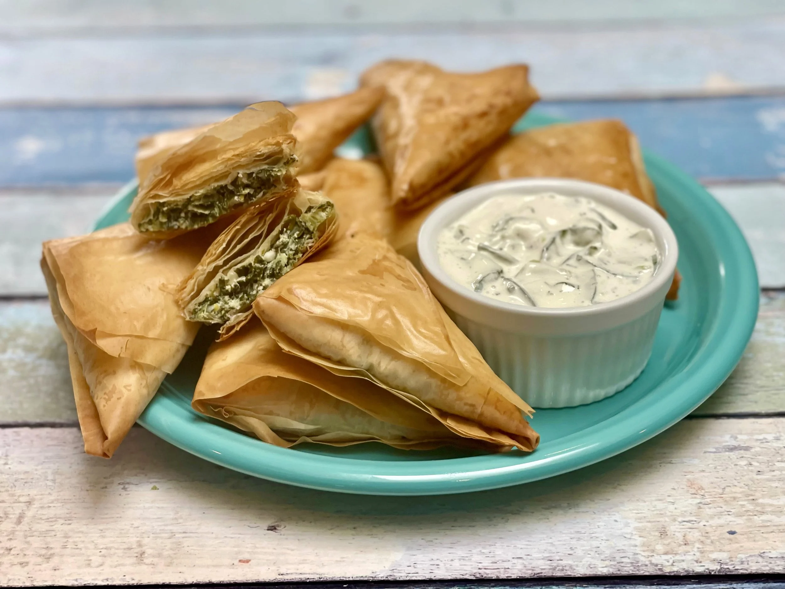 Serving spanakopita triangles