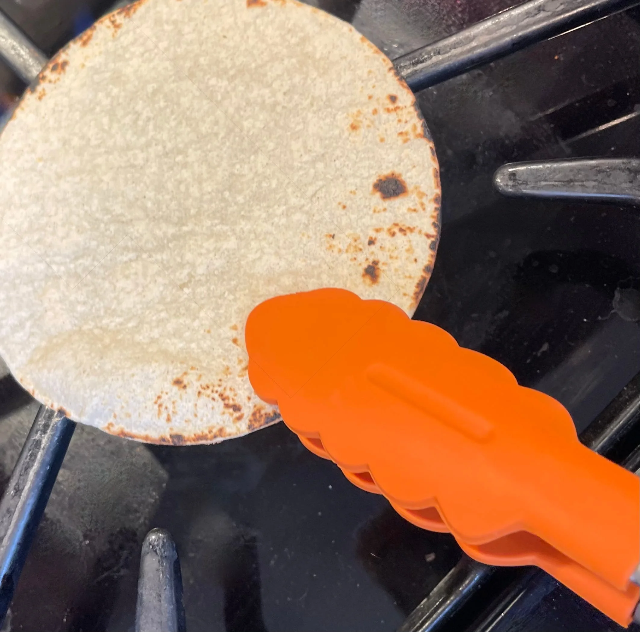 Warming the corn tortillas on the stove