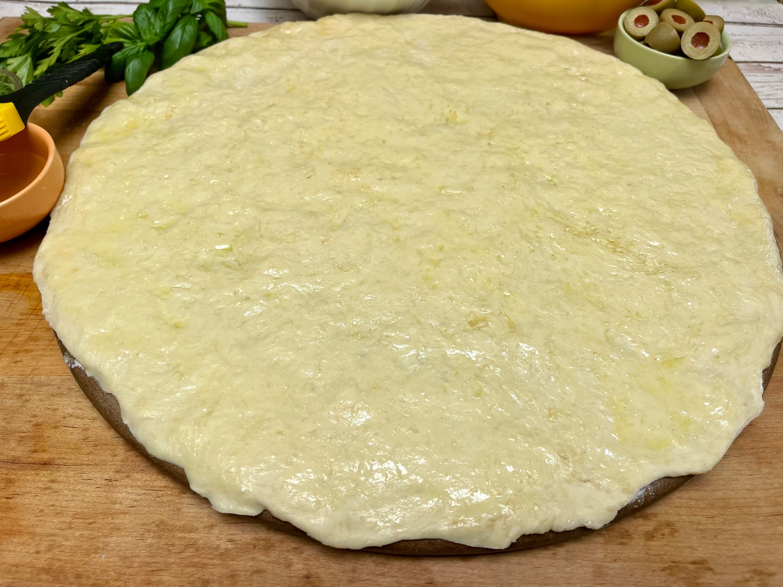 raw dough on pizza stone