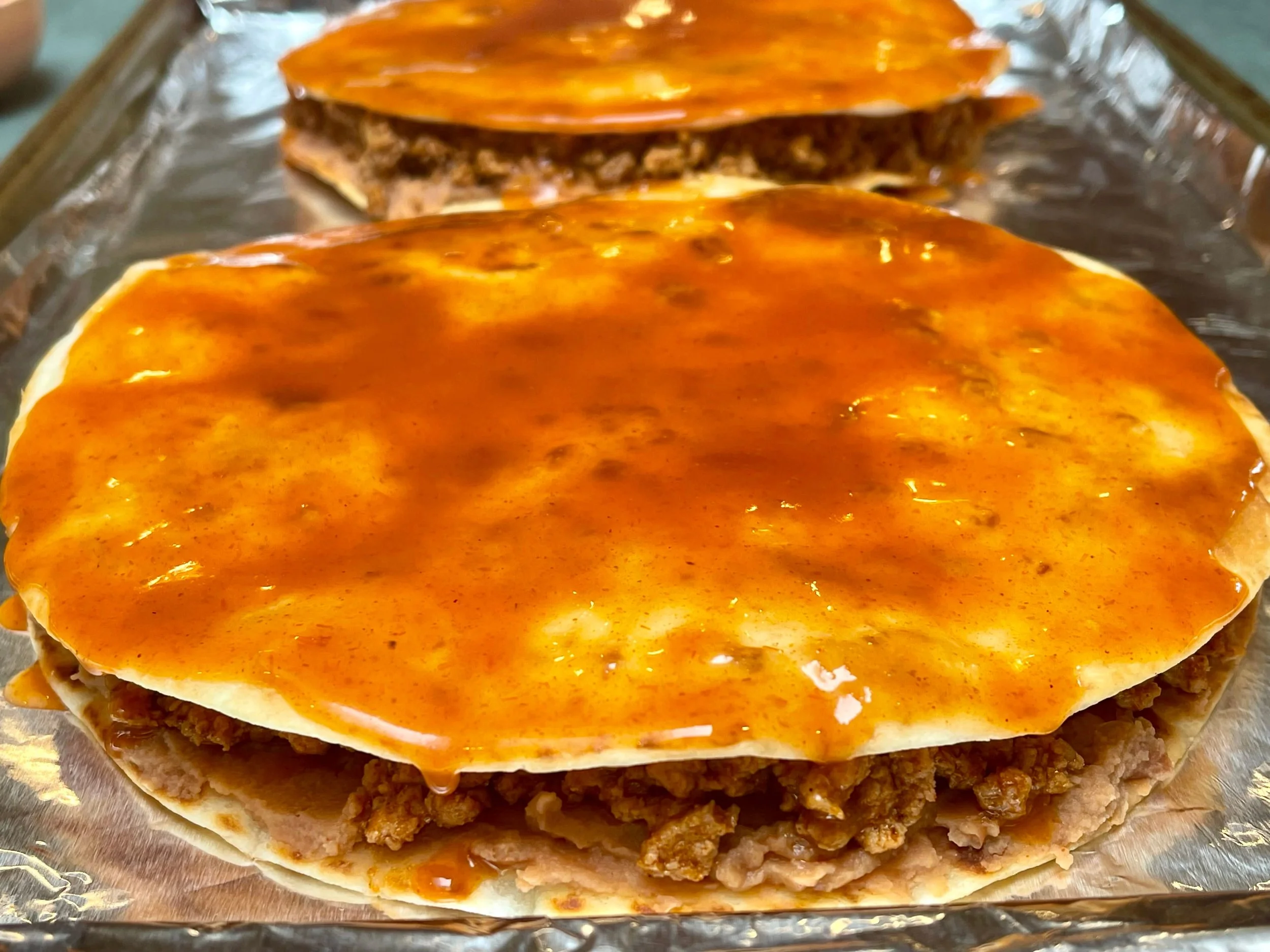Enchilada sauce on tortillas
