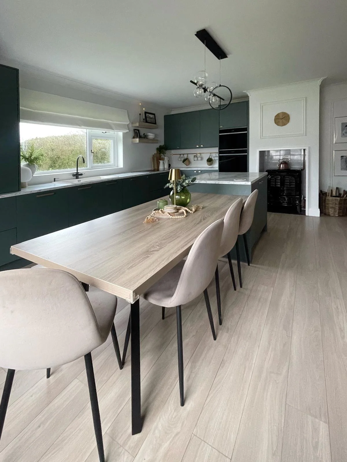 Bright kitchen with a central dining table, streamlined cabinetry, and a more connected family layout.