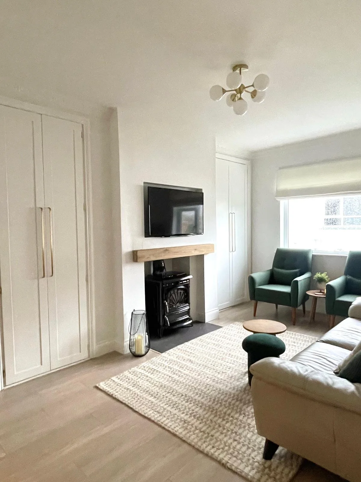 Panelled room detail with fitted storage, a black fireplace, and a soft neutral palette for a more elegant finish.