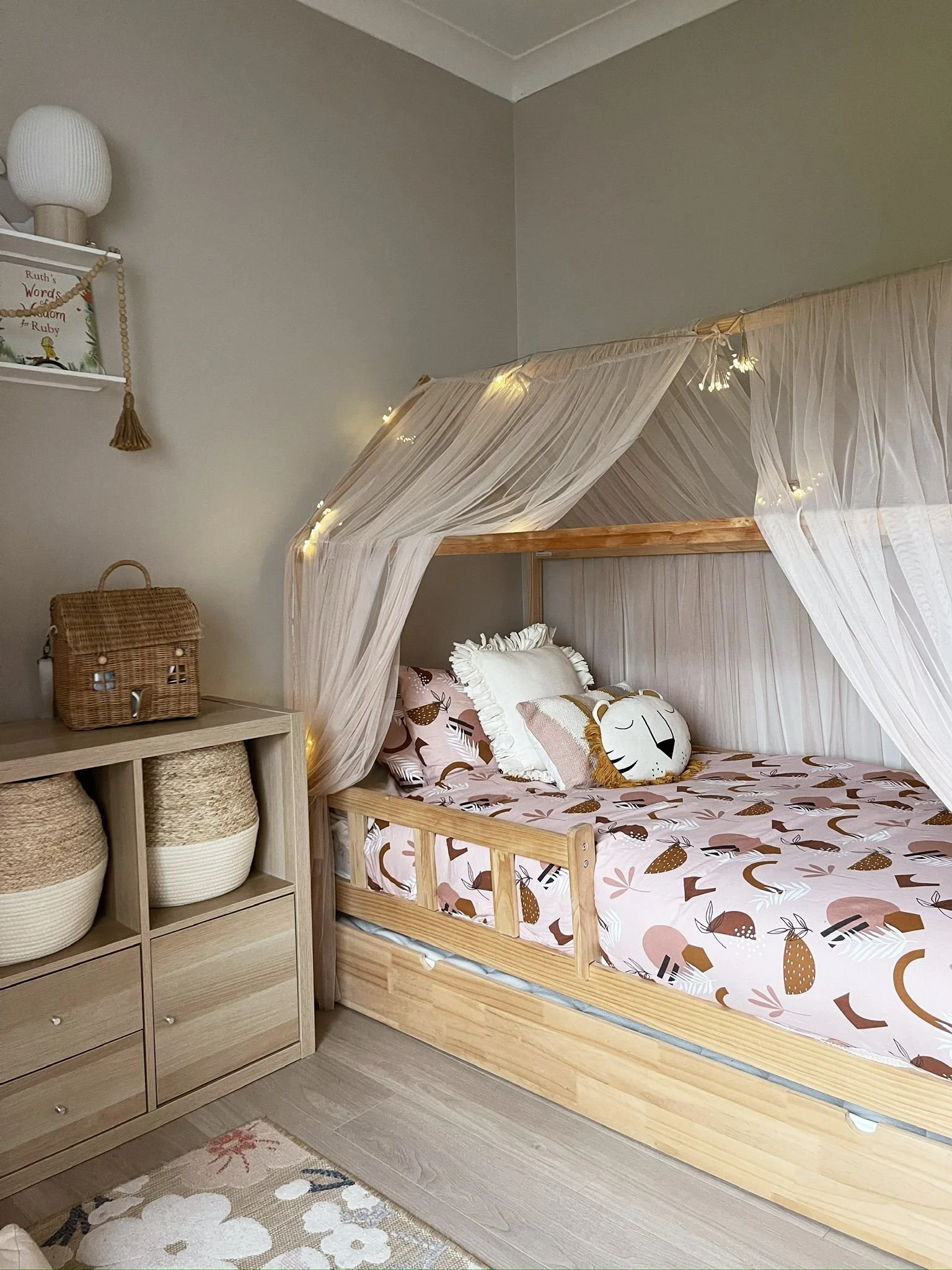 Children’s bedroom corner with layered textiles, woven storage, and a calm, softly styled feel.