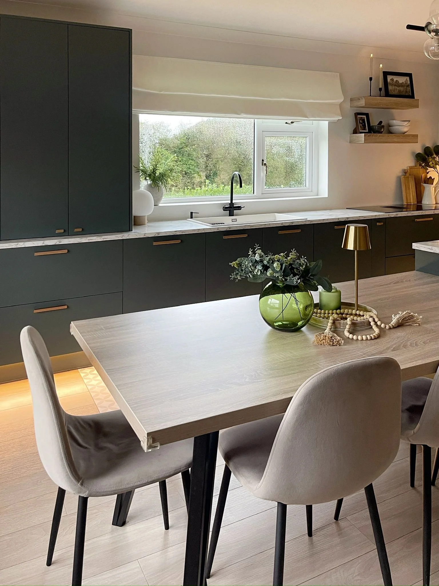 Dining area with soft upholstered seating, dark cabinetry, and a warm, practical family layout.