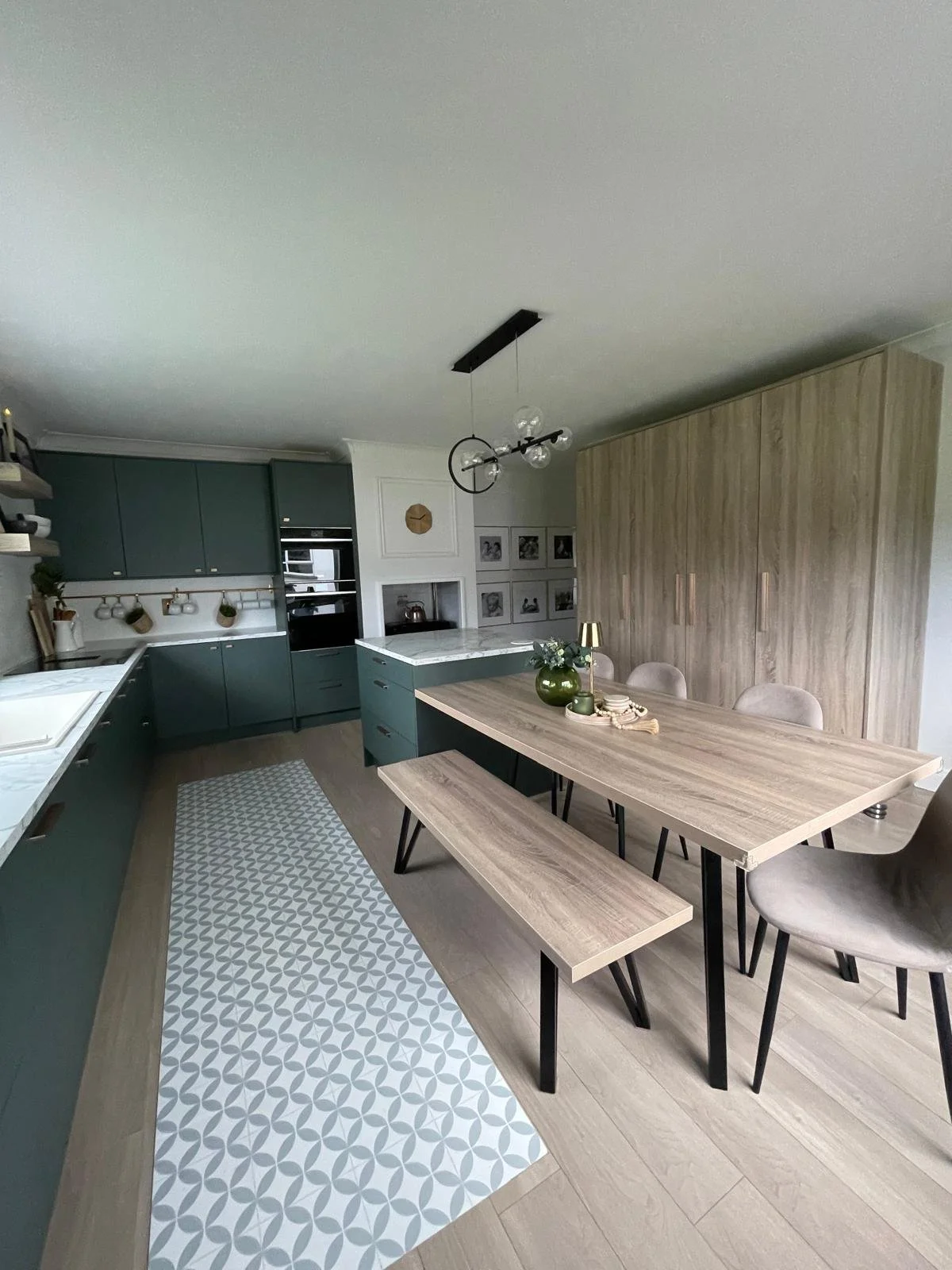 Open-plan kitchen and dining area with built-in bench seating, layered lighting, and a layout designed for everyday ease.