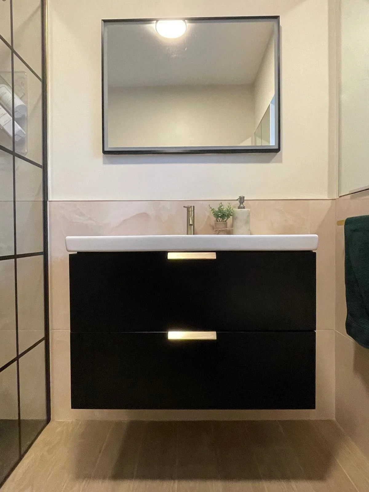 Contemporary bathroom vanity with dark cabinetry, clean lines, and a more polished, modern finish.