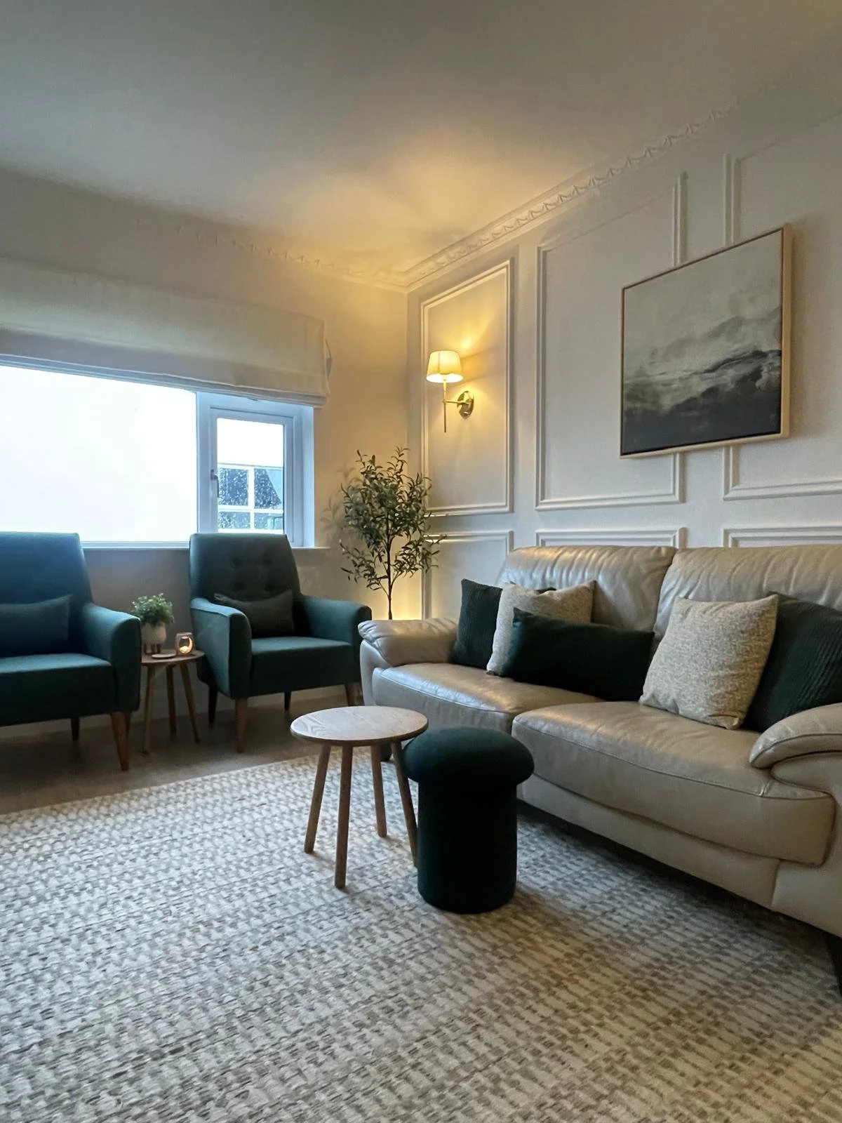 Living room with soft seating, layered lighting, and a calm, easy-to-live-in atmosphere.