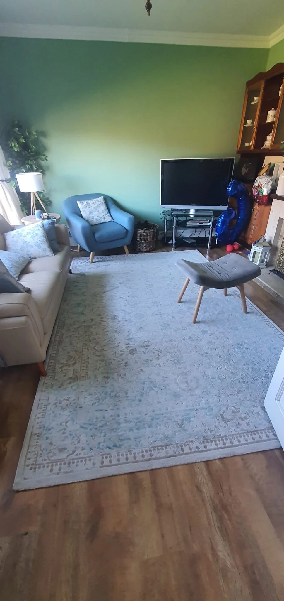 Before view of the sitting room showing the original layout, finishes, and overall room condition.