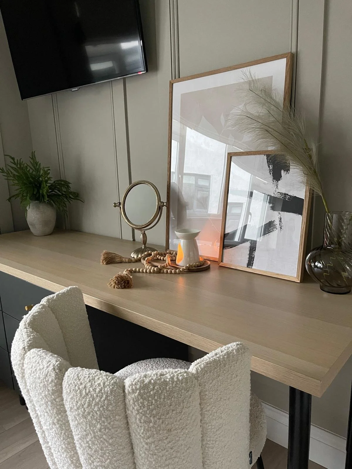 Bedroom vanity corner with soft lighting, warm neutrals, and a simple, elegant styling moment.