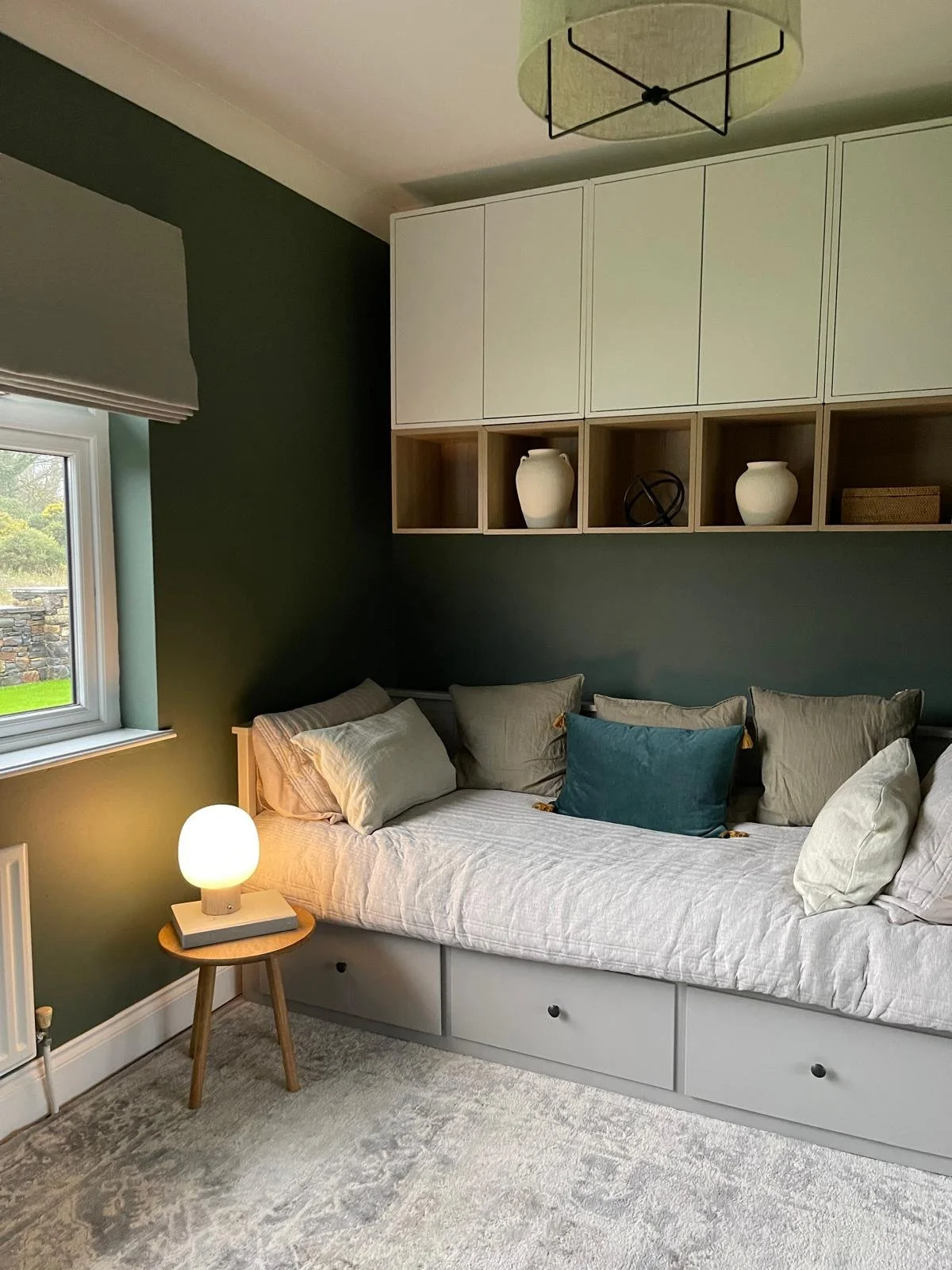 Guest bedroom and home office with soft neutral seating, layered lighting, and a calm layout designed for comfort and ease.
