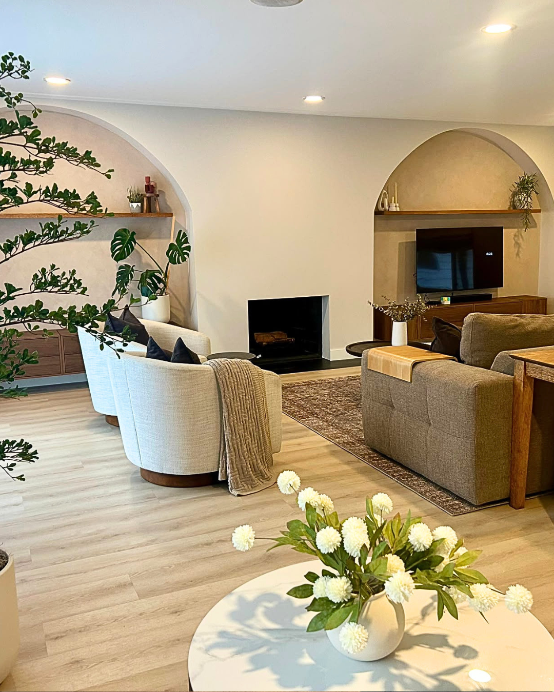 Open-plan family living room with fireplace, soft neutral seating, and a layout designed for better flow and everyday ease.