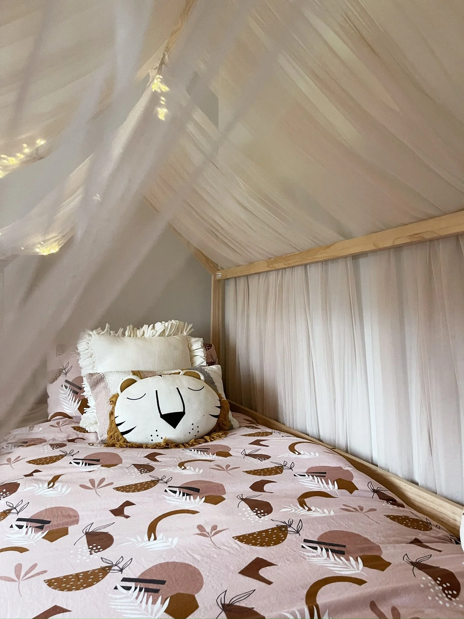 Children’s bedroom with a soft canopy bed, playful bedding, and a cosy tucked-away sleeping nook.