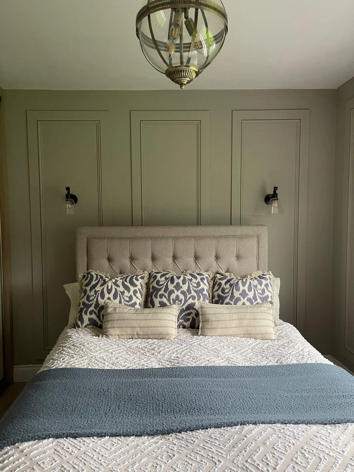 Front-facing bedroom view with bespoke wall panelling, balanced symmetry, and a more refined, restful feel.