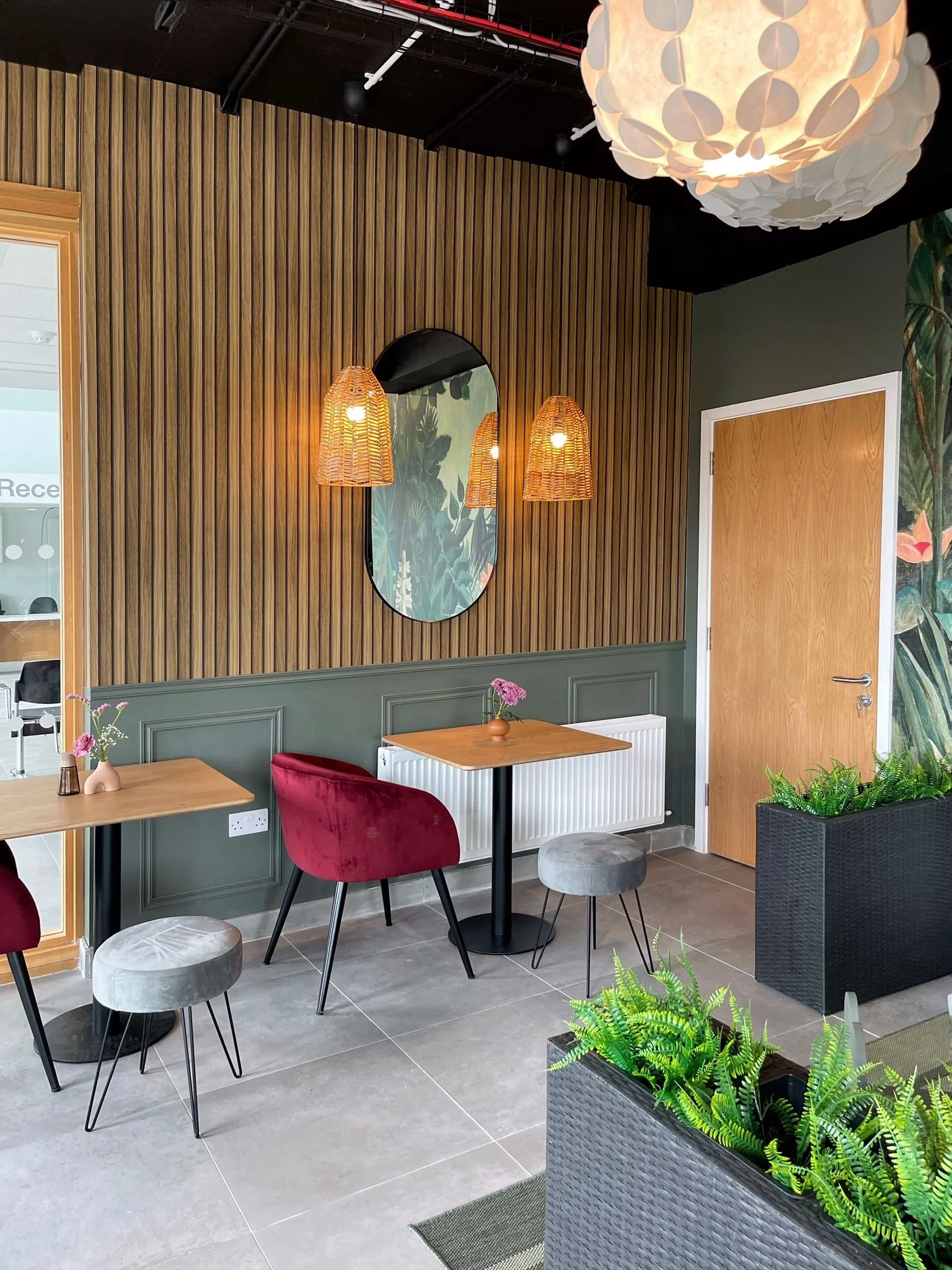 Close-up of timber slat detailing, wall lighting, and warm natural textures in the dining space.
