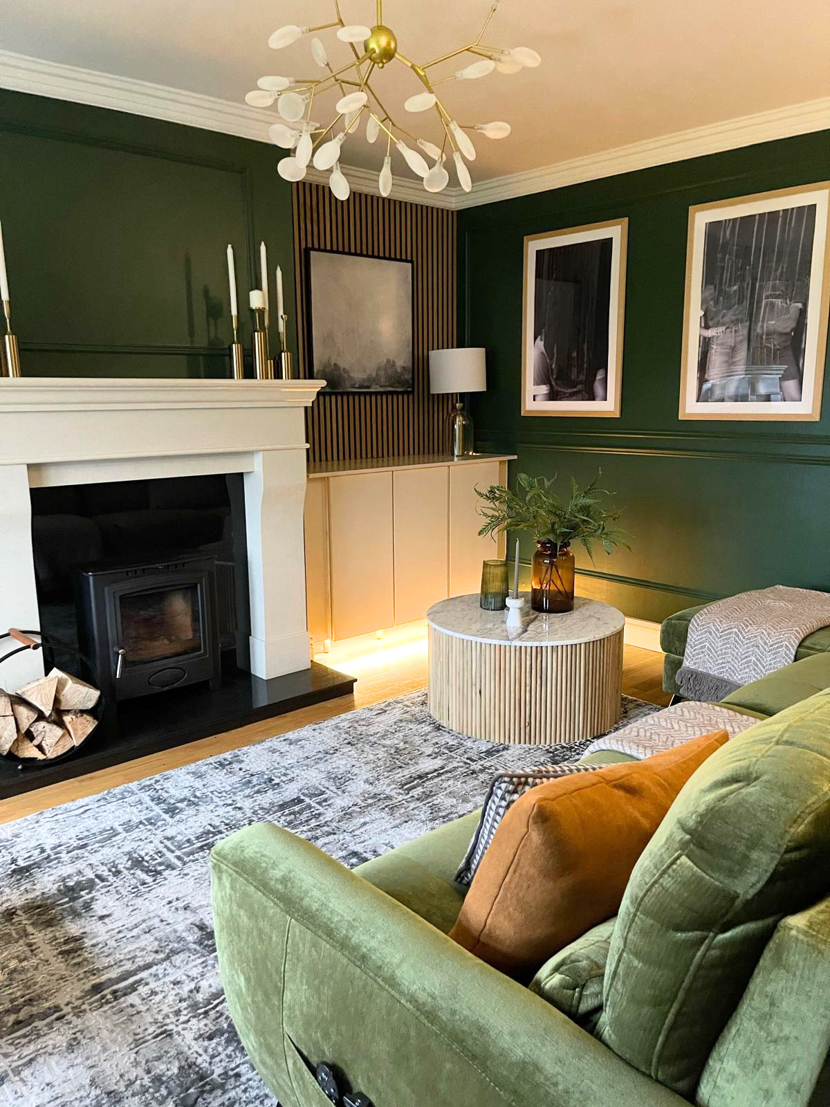 Fireplace-centred seating area with deep green walls, soft lighting, and a layout designed for comfort and conversation.