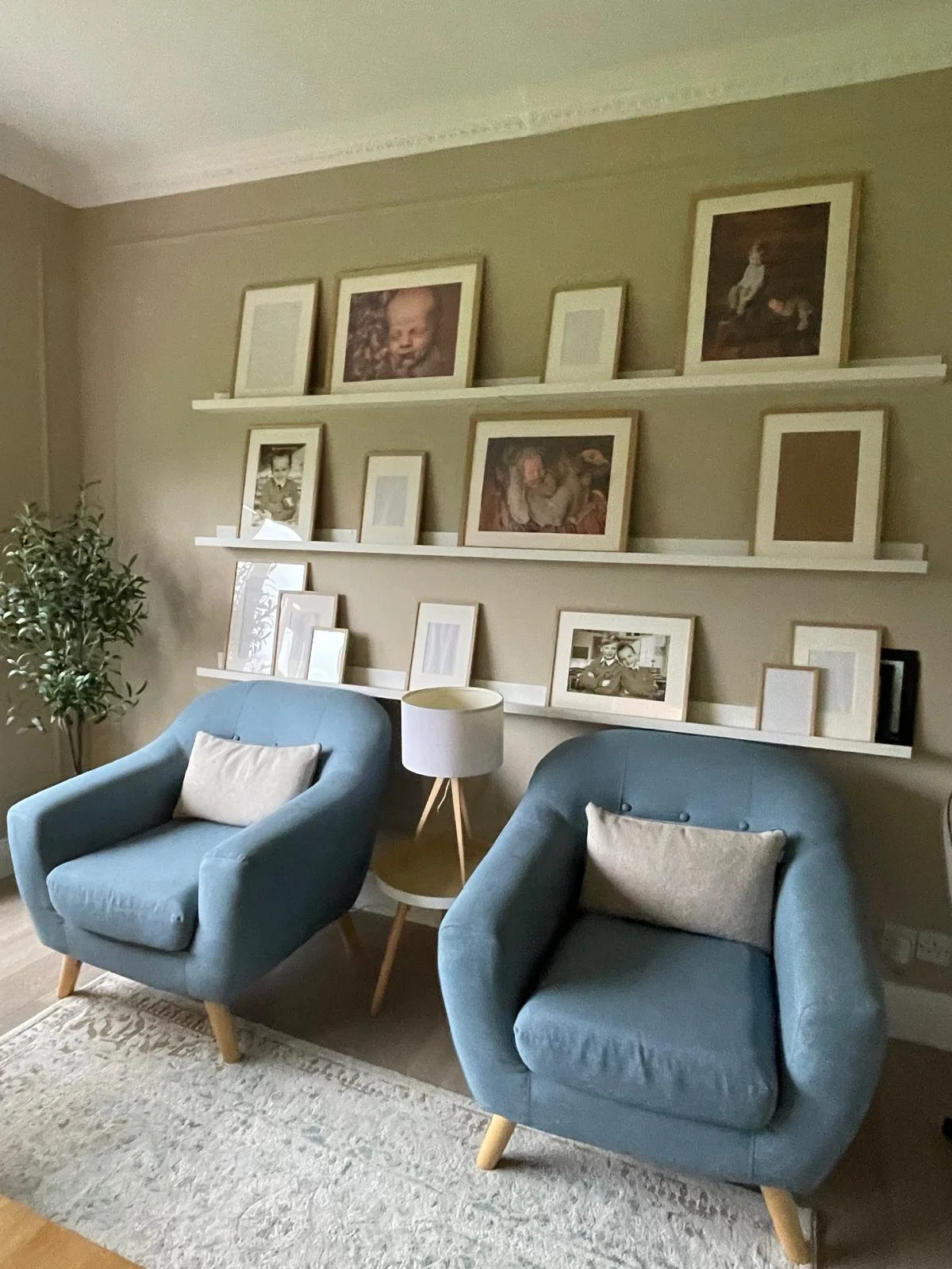 Seating nook with neutral walls, layered cushions, and open shelving for a cosy, restful corner.