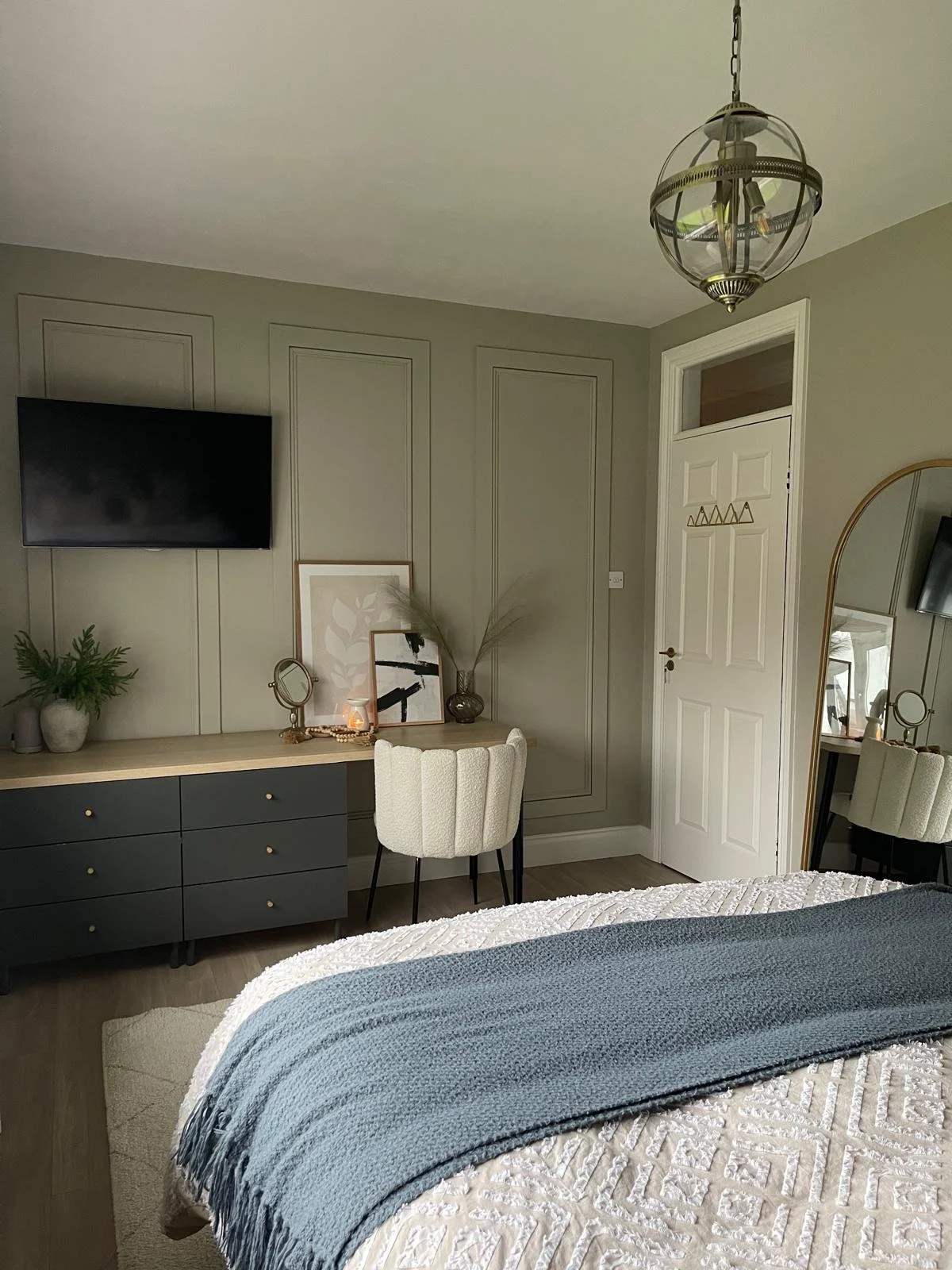 Bedroom view with fitted storage, layered soft furnishings, and a calmer, more cohesive layout.