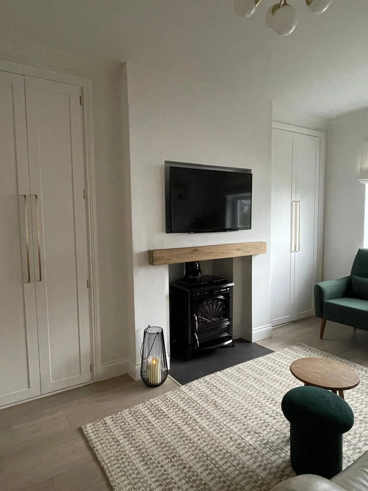 Fireplace wall with hot presses, soft wall panelling, and a calm, cohesive connection to the living space.