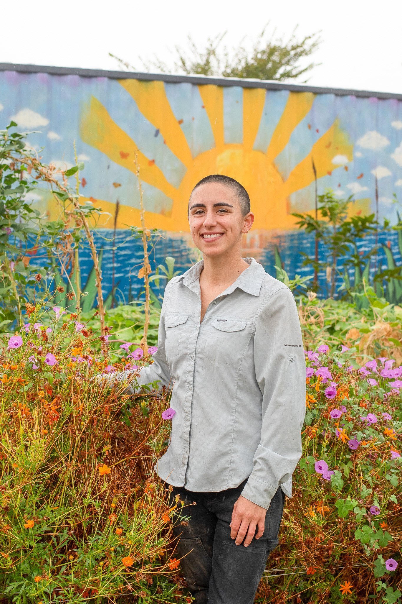   Farmer Anamaria Gutierrez, who has managed the garden for the last three years, poses for a portrait in front of the tool shed Sept. 13. Gutierrez is a first-generation Mexican American who grew up on the border in south Texas. As garden manager, G
