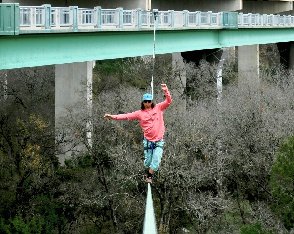  Aaron Yang centers himself on a slack line attached to the Barton Creek Greenbelt on Wednesday, Dec. 20, 2023. Photo captured by Alec Barrett.  