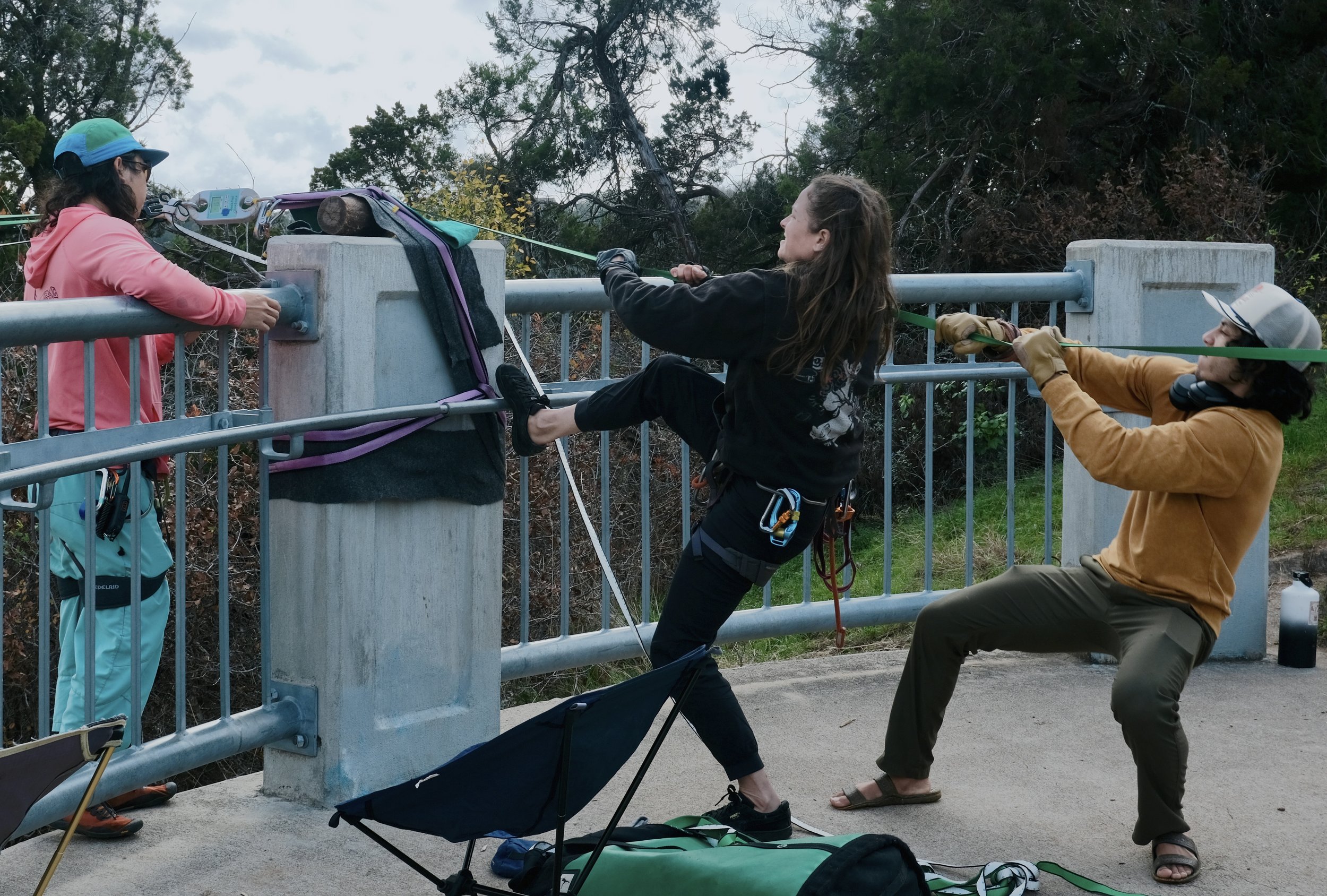  Aaron Yang, Kate Archer, and Muhammad “Mo” Martinez work hard to set up their slack line along the Barton Creek Greenbelt on Wednesday, Dec. 20, 2023. Photo captured by Alec Barrett. 