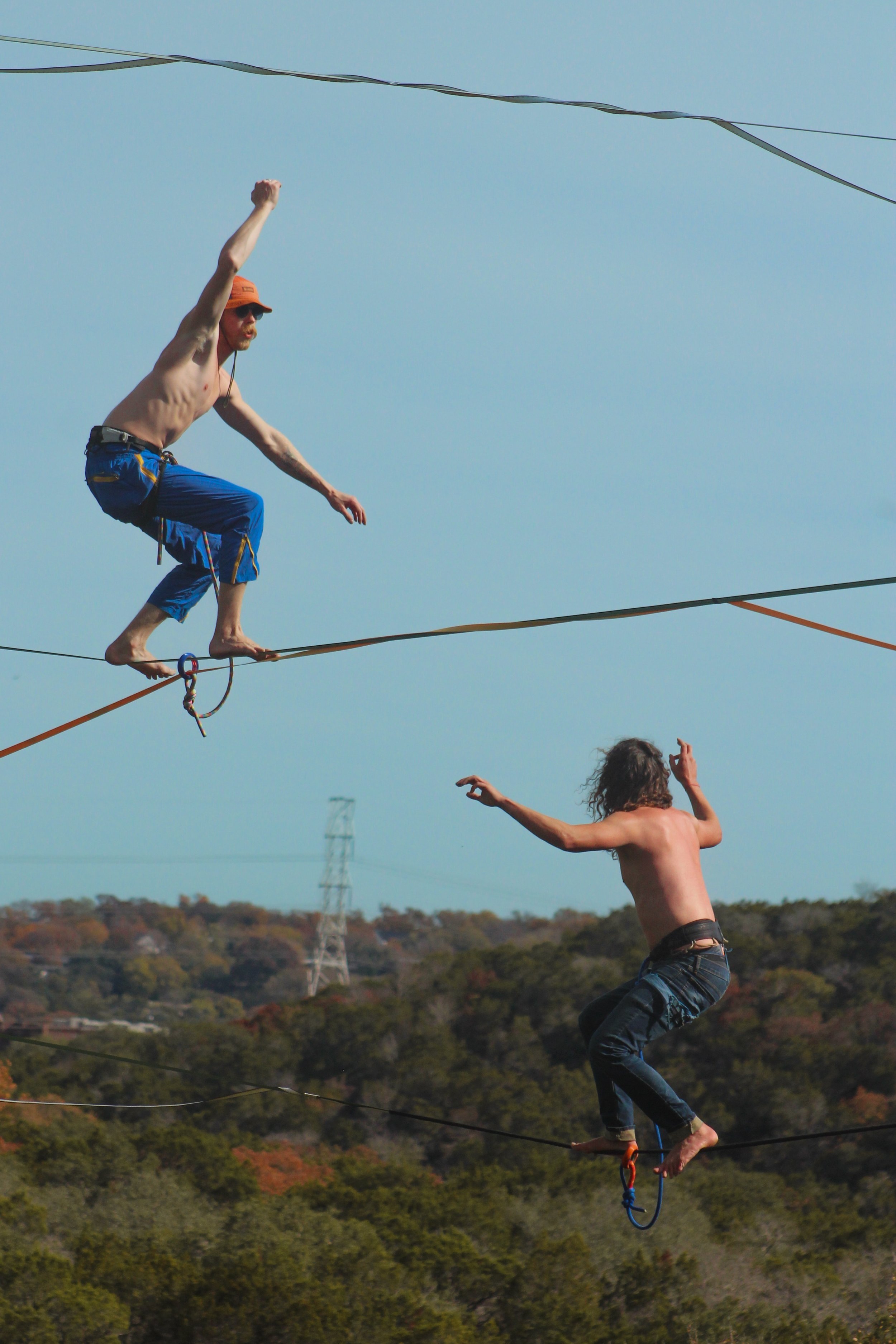  Elias King (top) and Tim Goelz (bottom) balance on their slack lines over Barton Creek Greenbelt on Sunday, Dec. 3, 2023.&nbsp;Photo captured by Chloe Rech. 