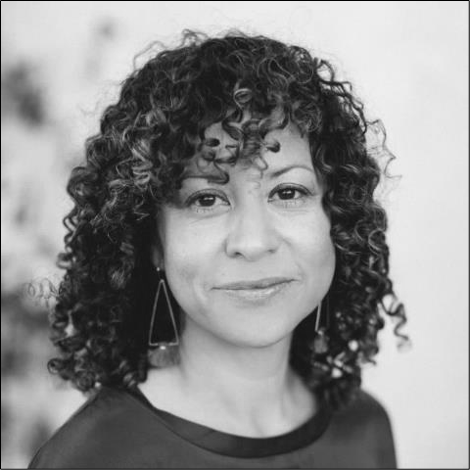 Black and white portrait of a woman with curly hair, wearing earrings and a dark top.
