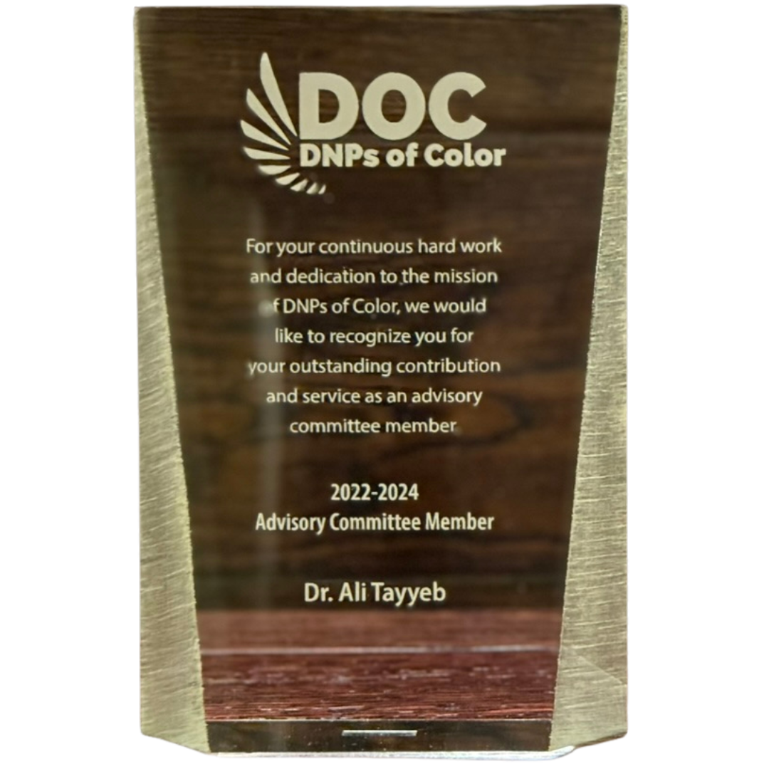 A wooden plaque with a logo and text recognizing Dr. Ali Tayyeb for his contribution as an advisory committee member for DNPs of Color from 2022 to 2024.