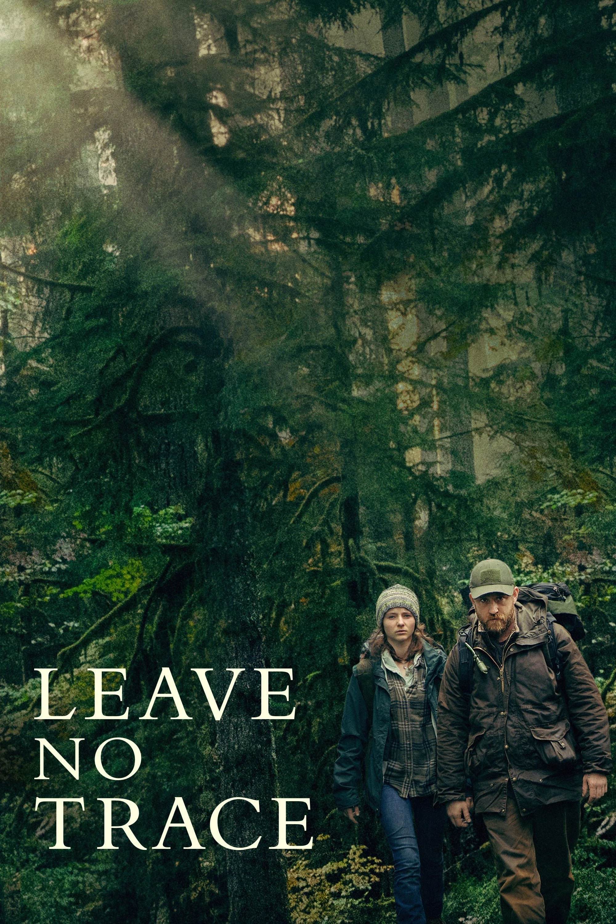 Two hikers, a woman and a man, walking through a dense, foggy forest with tall trees and lush greenery, with the text 'LEAVE NO TRACE' displayed on the left side.