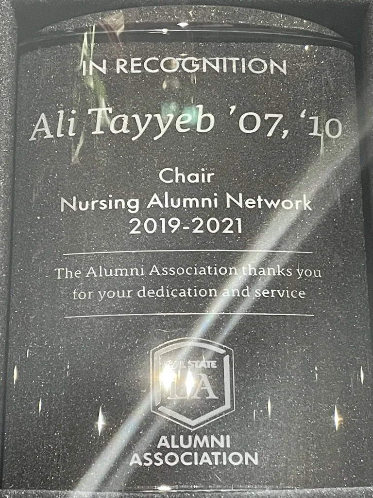 A glass plaque recognizing Ali Tayyeb for his dedication as Chair of the Nursing Alumni Network from 2019 to 2021, thank you message from the Alumni Association, with the All State CA logo at the bottom.