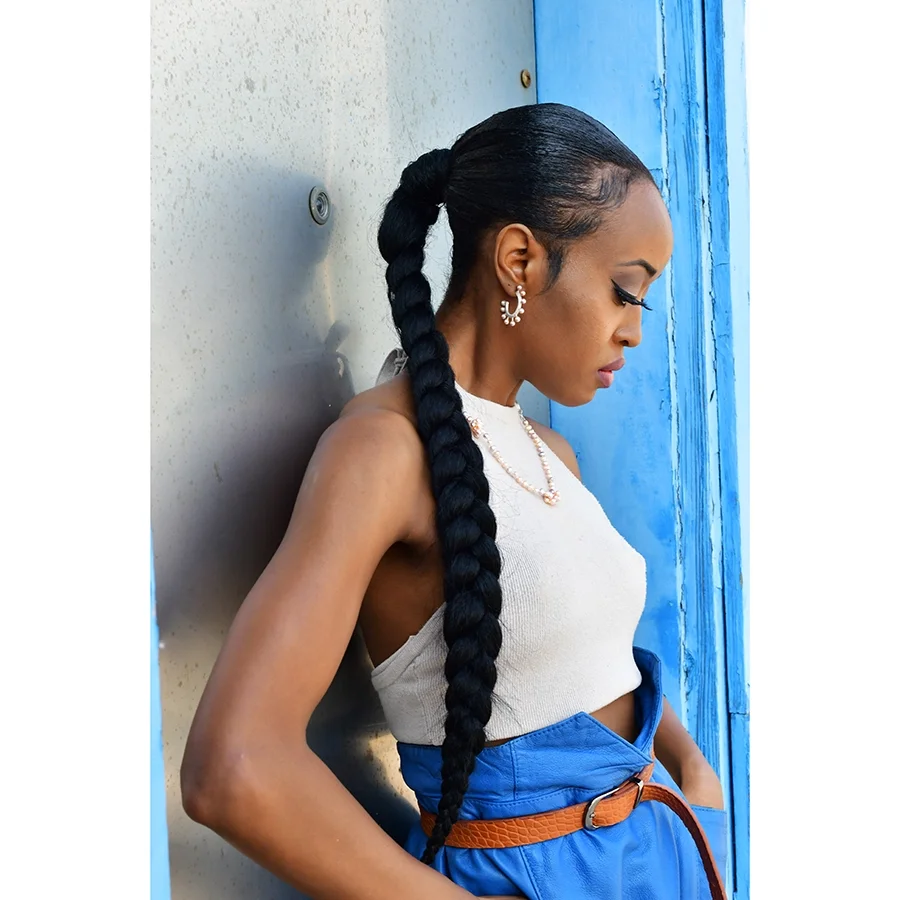 woman with long black braid blye skirt and white tee with sterling silver pink pearl earrings