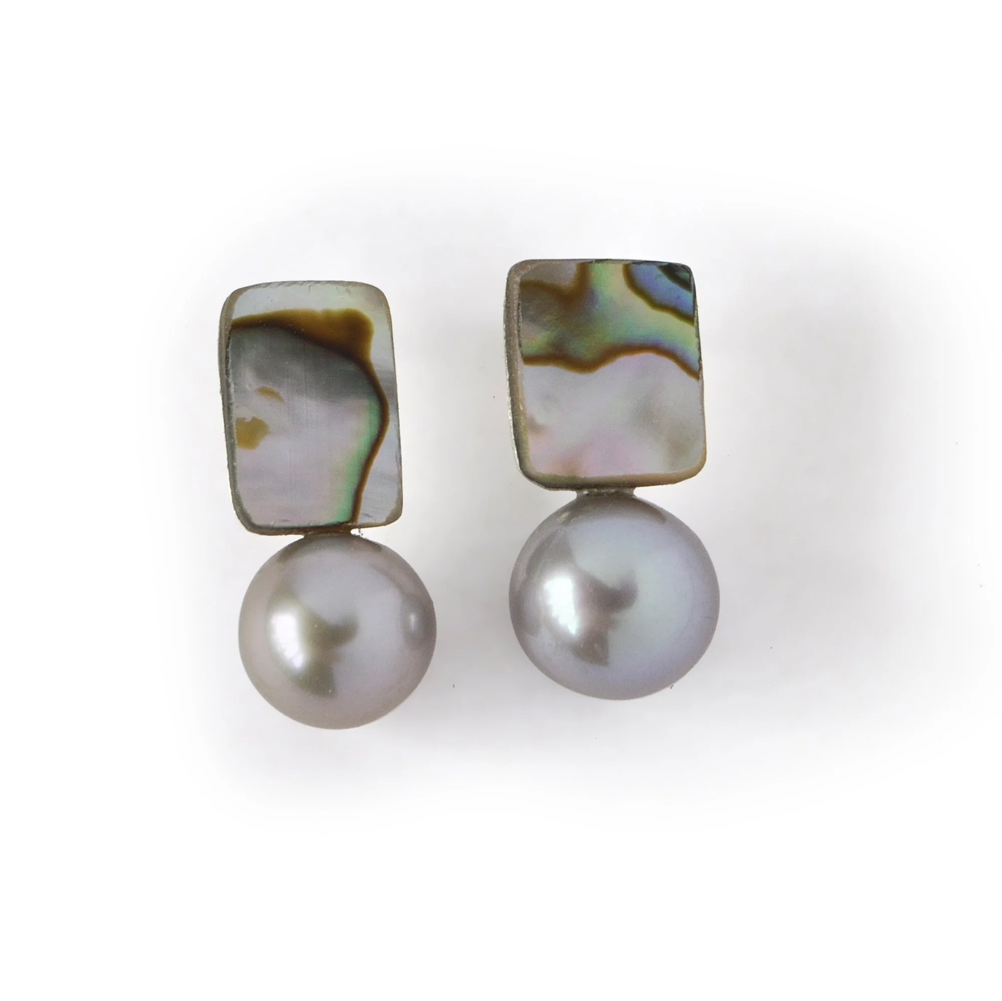 waves of blue, green, pink and blue on a small shell piece next to a big luscious silver freshwater pearl