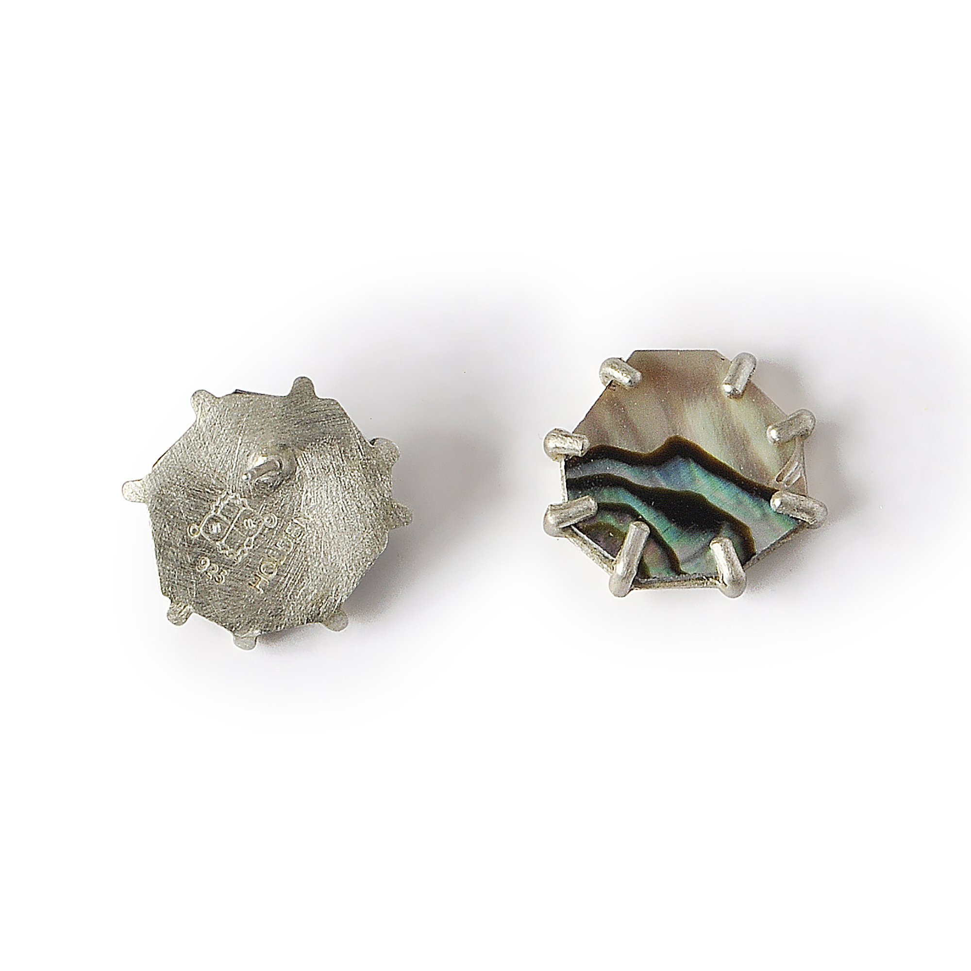 small abalone earrings with one faced backward so you can see post and artist's hallmark stamped on silver back on earring