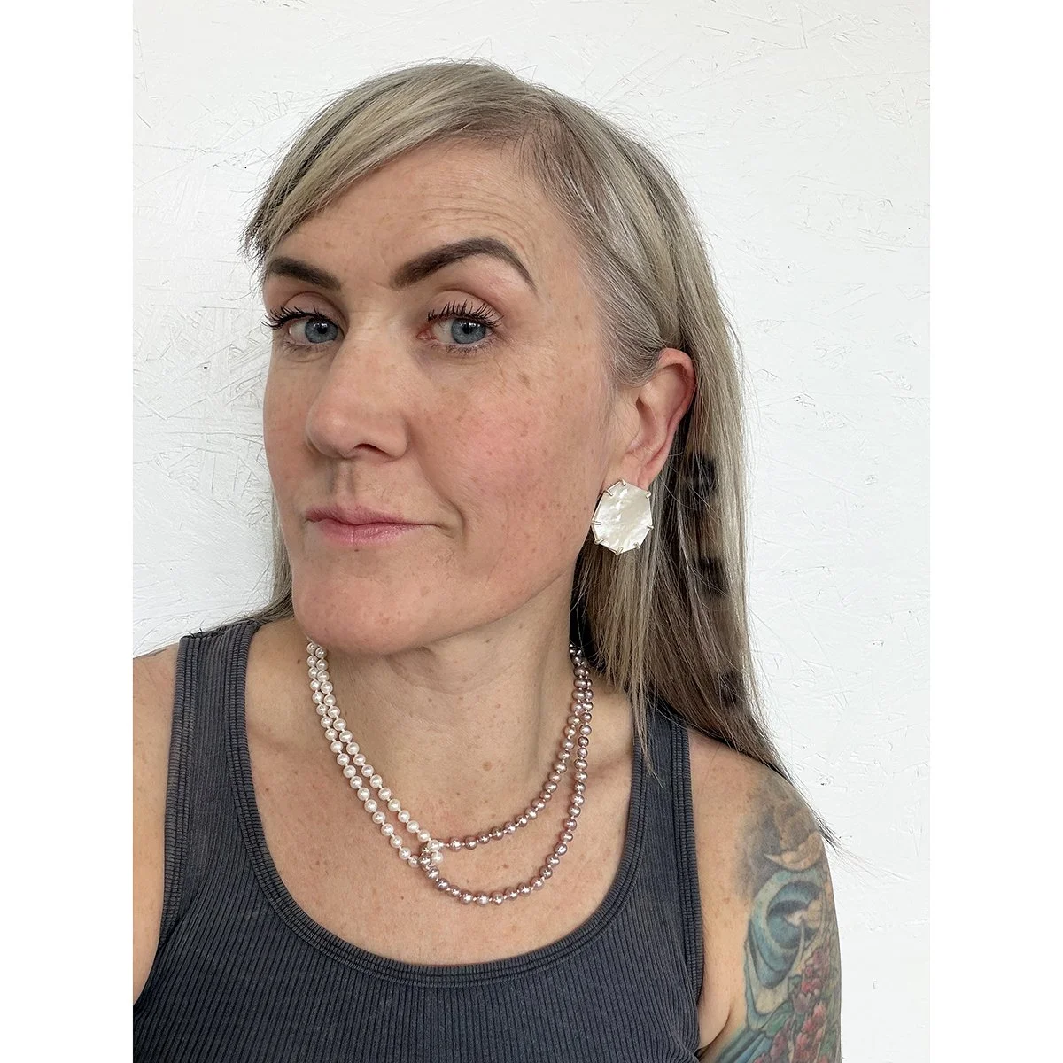 pink and white pearl necklace on woman with blonde hair