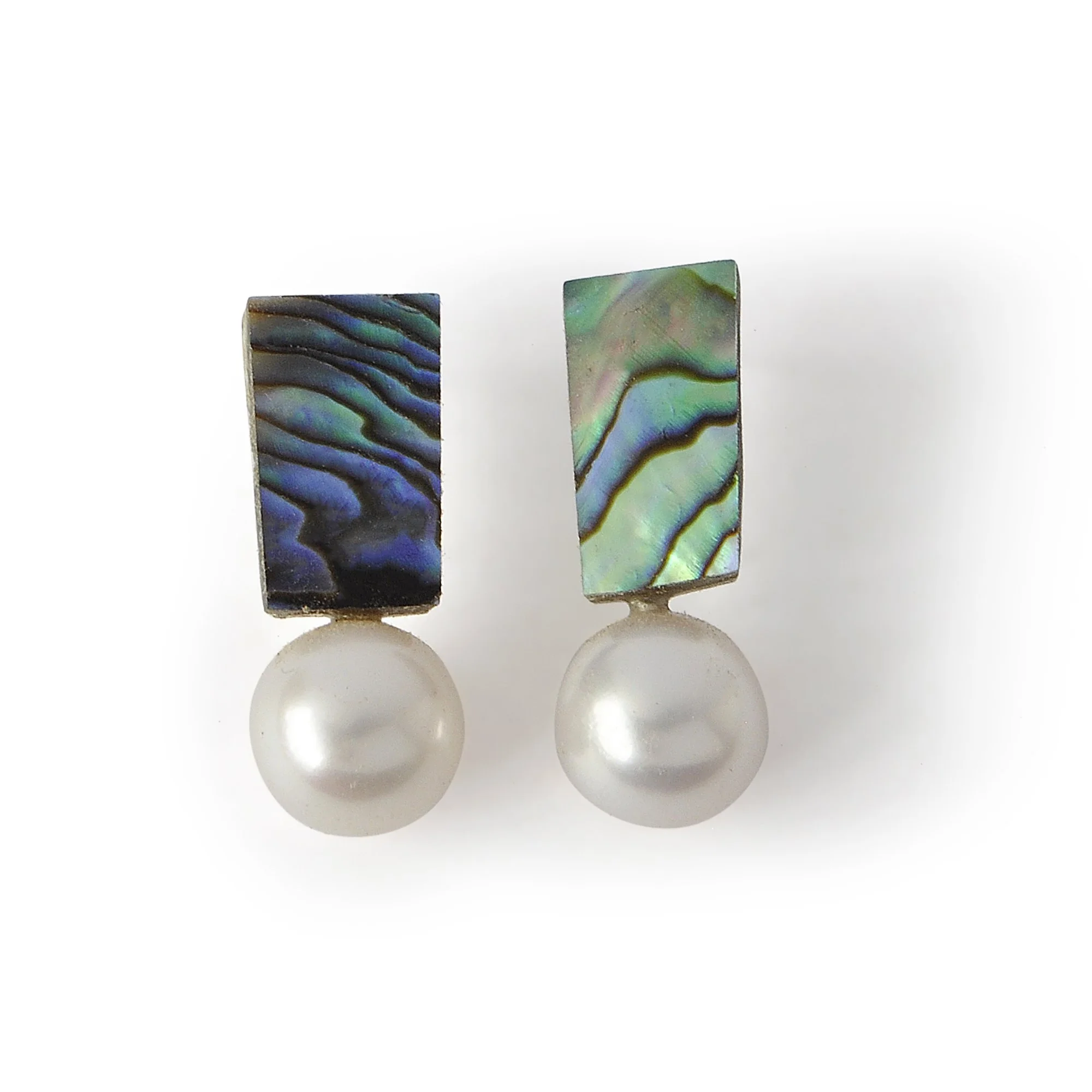 dark green abalone with deep purples and blues next to perfect round white freshwater pearl