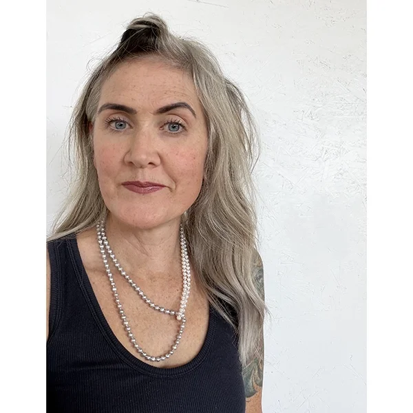 woman with blonde hair and pink lips wearing white and silver freshwater pearl necklace