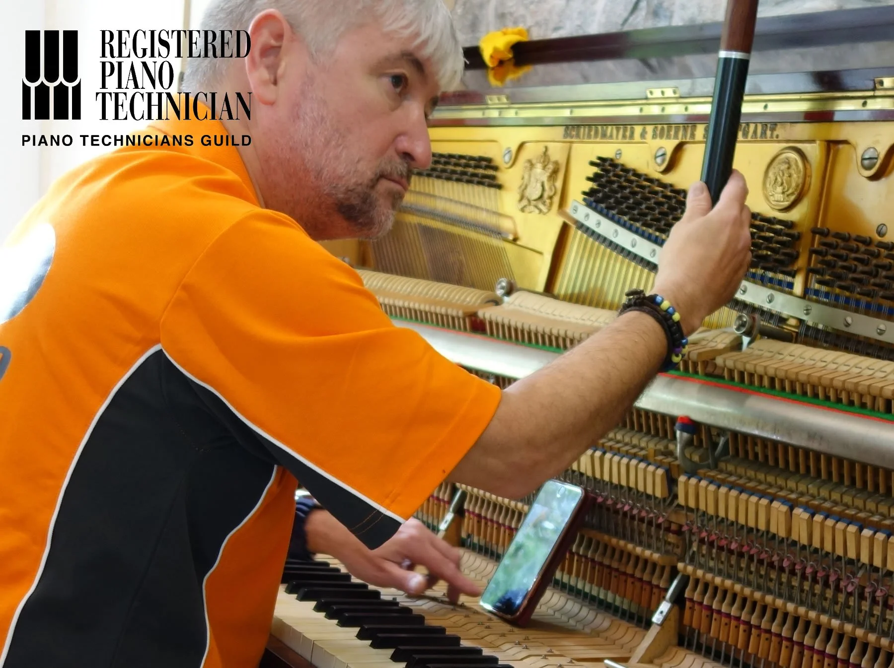 Chris Hacking tuning a Scheidmayer piano as a registered piano technician of the Piano Technicians Guild