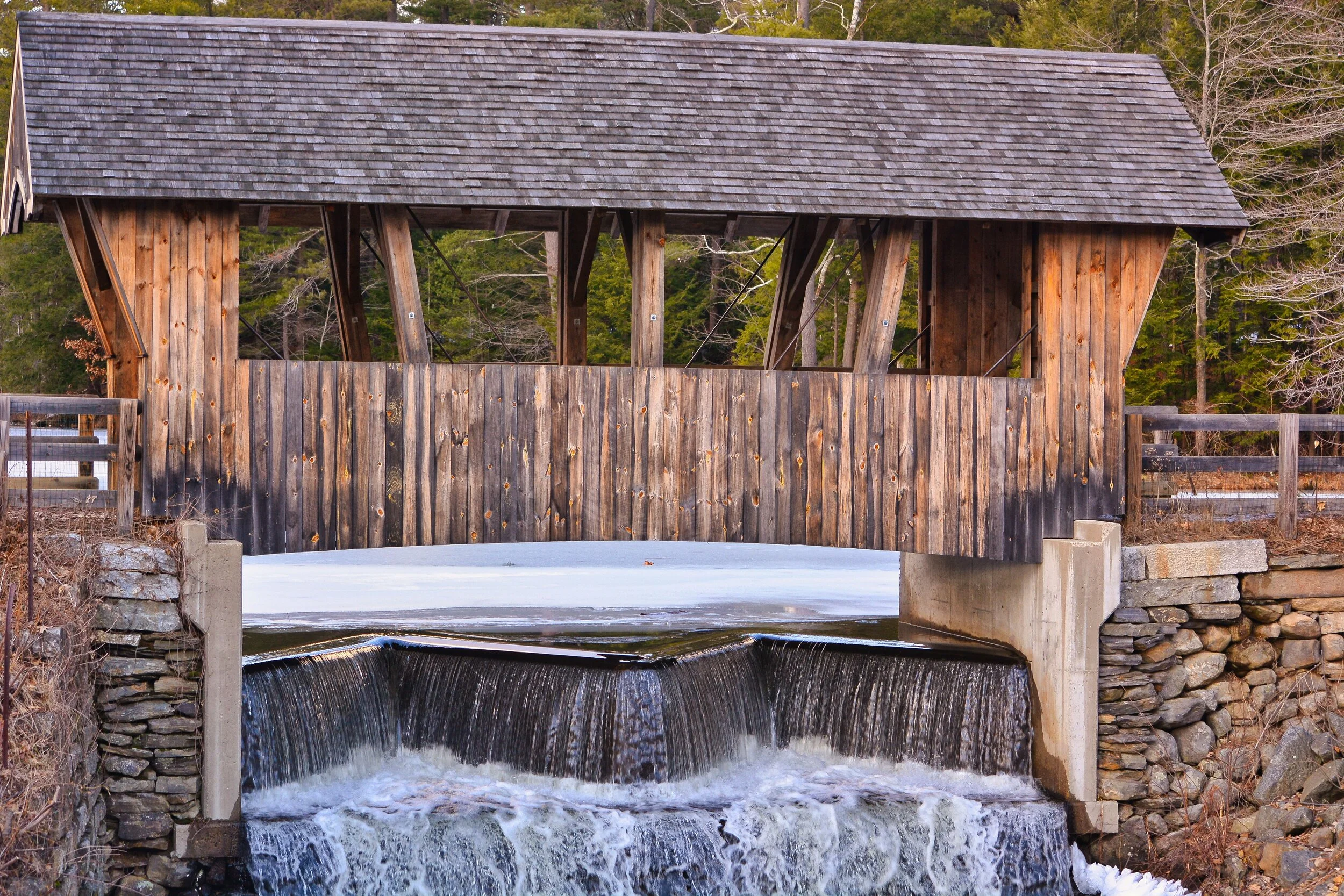 Winter's Silent Passage: The Covered Bridge Over Frozen Falls