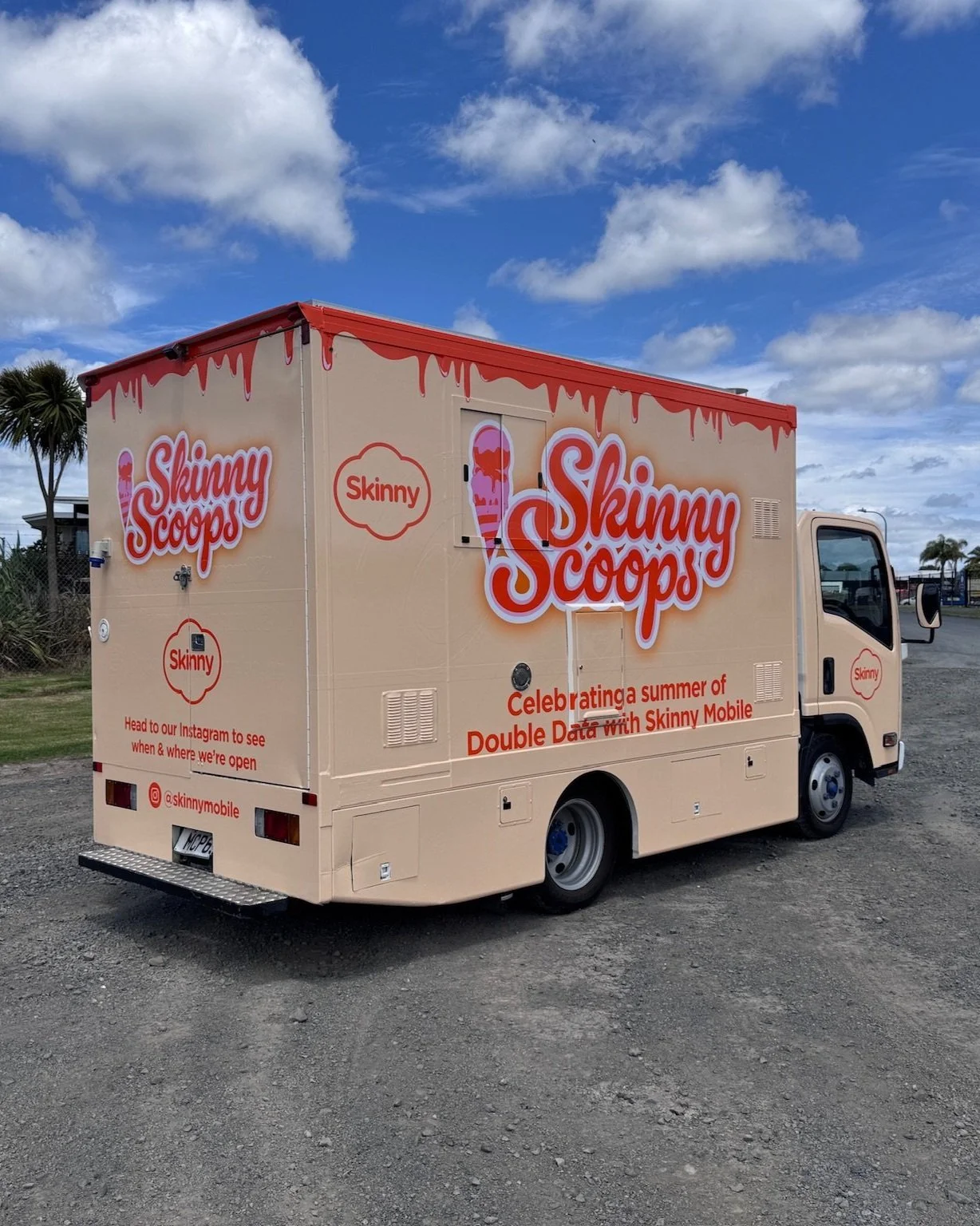Ice cream truck labeled "Skinny Scoops" with promotional text for Skinny Mobile.