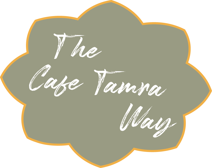 A logo in the shape of a flower text inside reads "The Cafe Tamra Way" in white, cursive font.