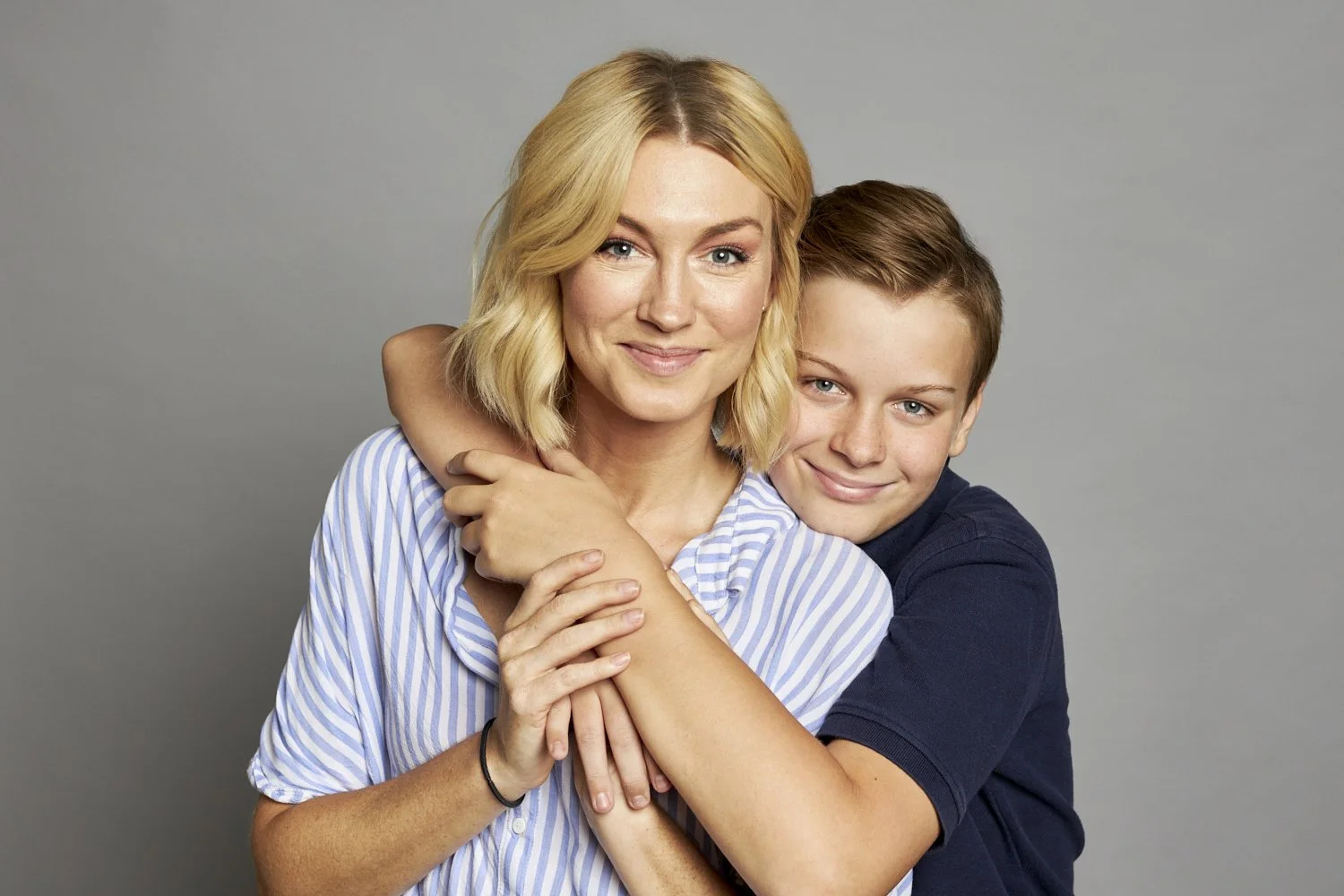 Professional portrait featuring a mother with her son who is on the autism spectrum.