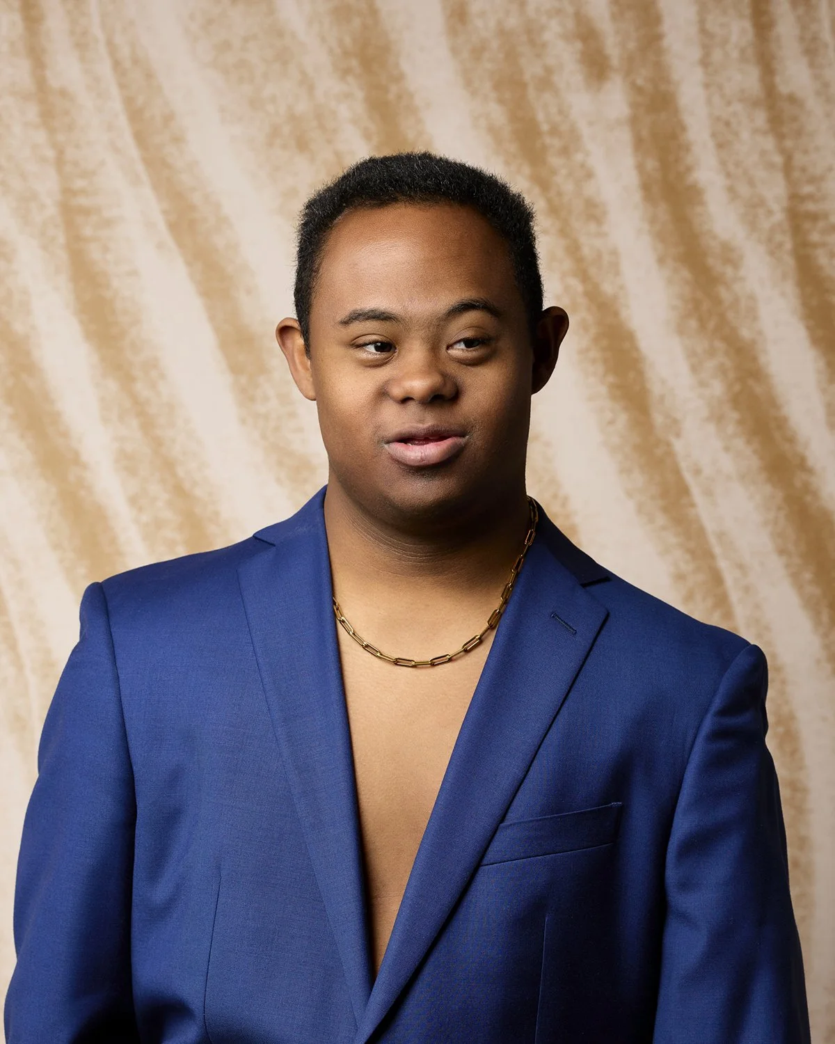 Professional portrait of a young adult with Down Syndrome.