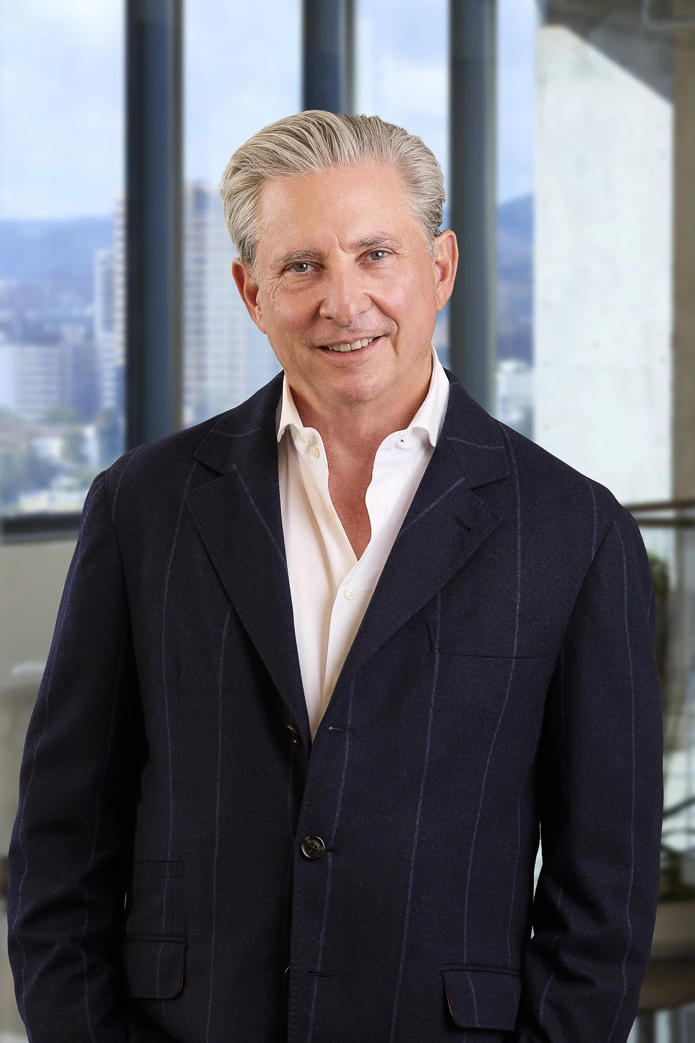 Professional corporate headshot featuring Ares Management Corporation's Co-Founder, and LAFC Owner, Bennett Rosenthal.