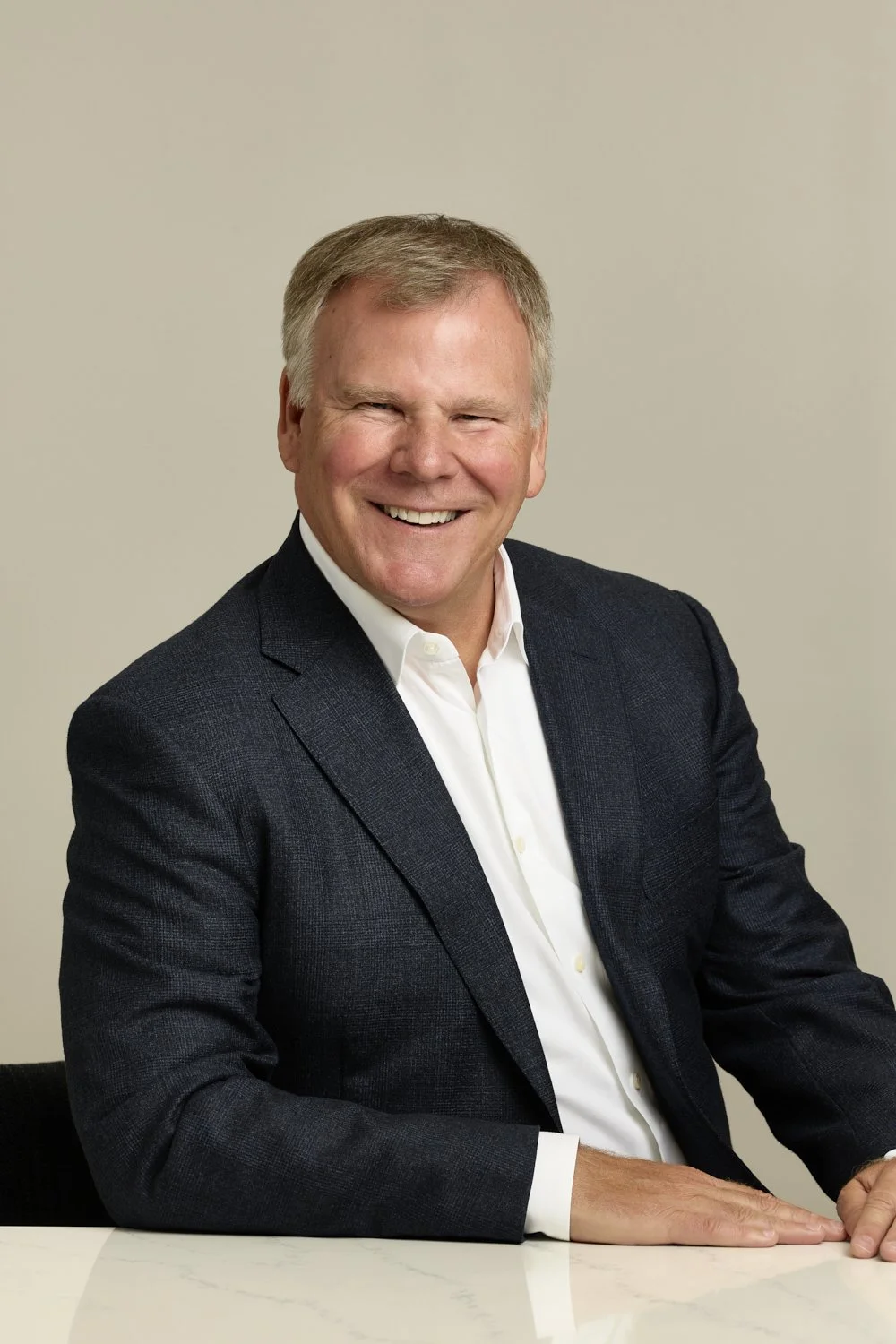 Professional corporate headshot featuring the CEO of Qdoba; John Cywinski.