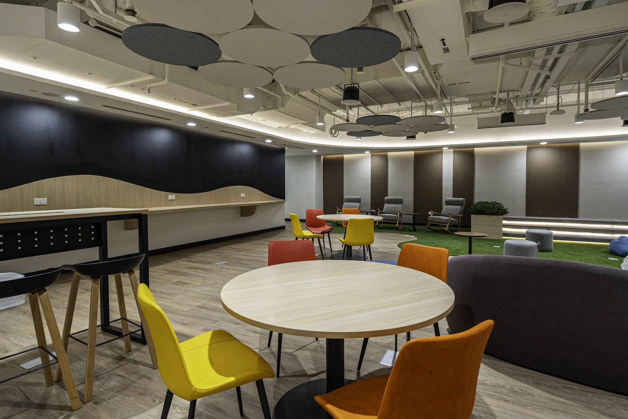 A fun games room with innovative acoustic ceiling baffles at the revamped Civil Service College interior design makeover