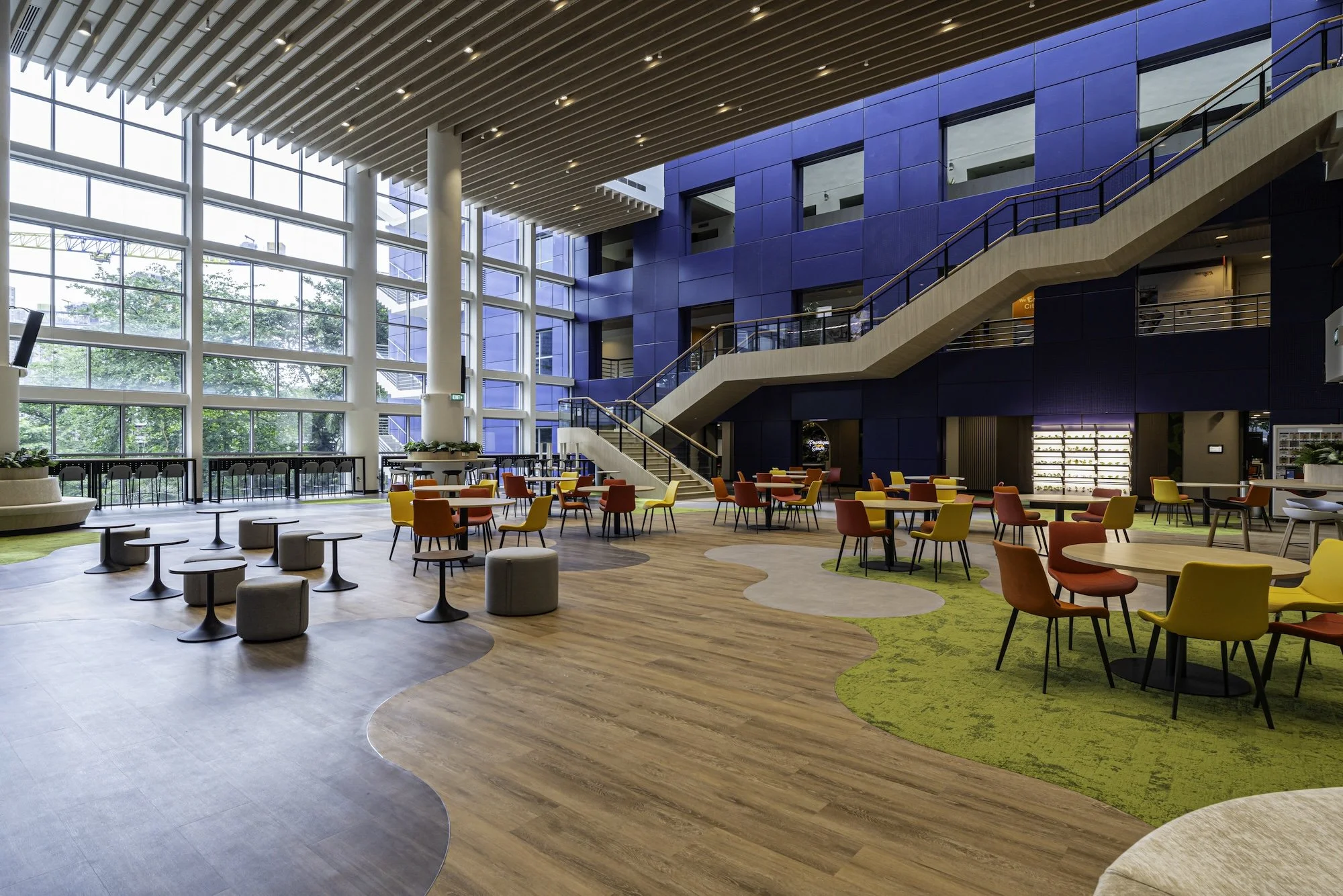 The Civil Service College atrium's staircase redesigned, redressed and updated to augment the original blue aluminium clad wall