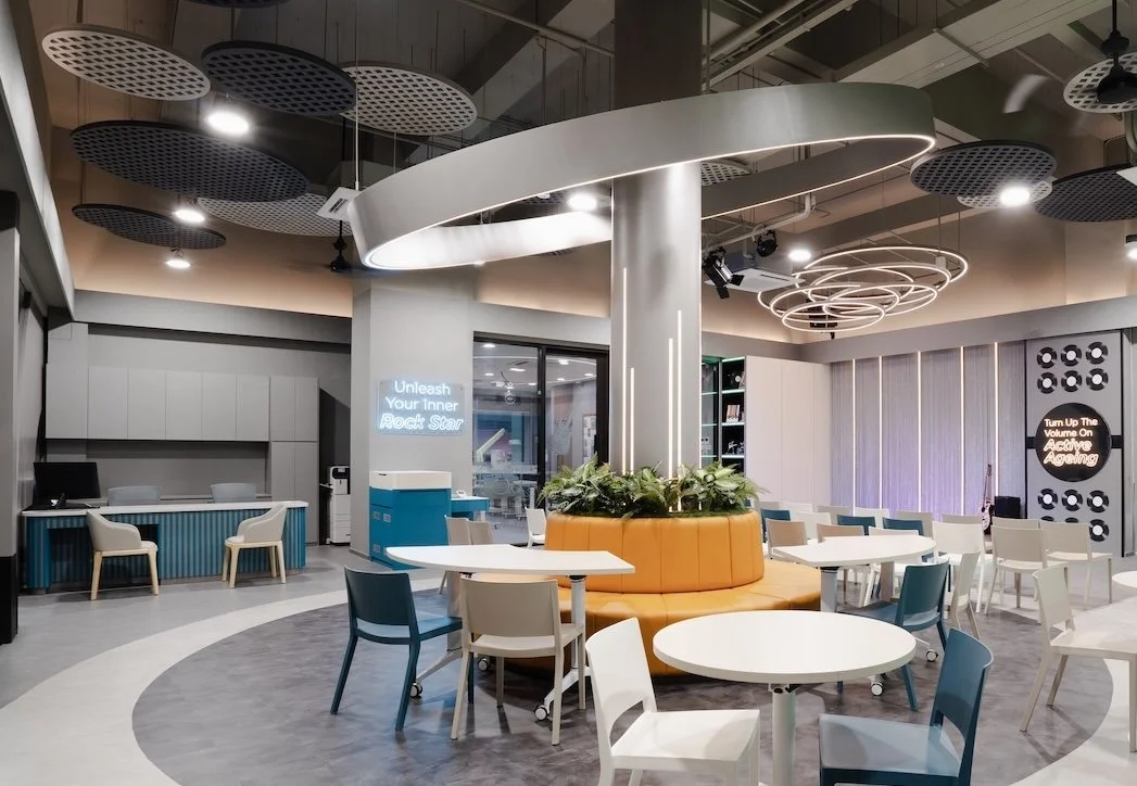 NTUC Health Active Ageing Centre @ Bukit Panjang with cantilevered circular light around pre-existing pillar, dressed up to anchor the space, close up view