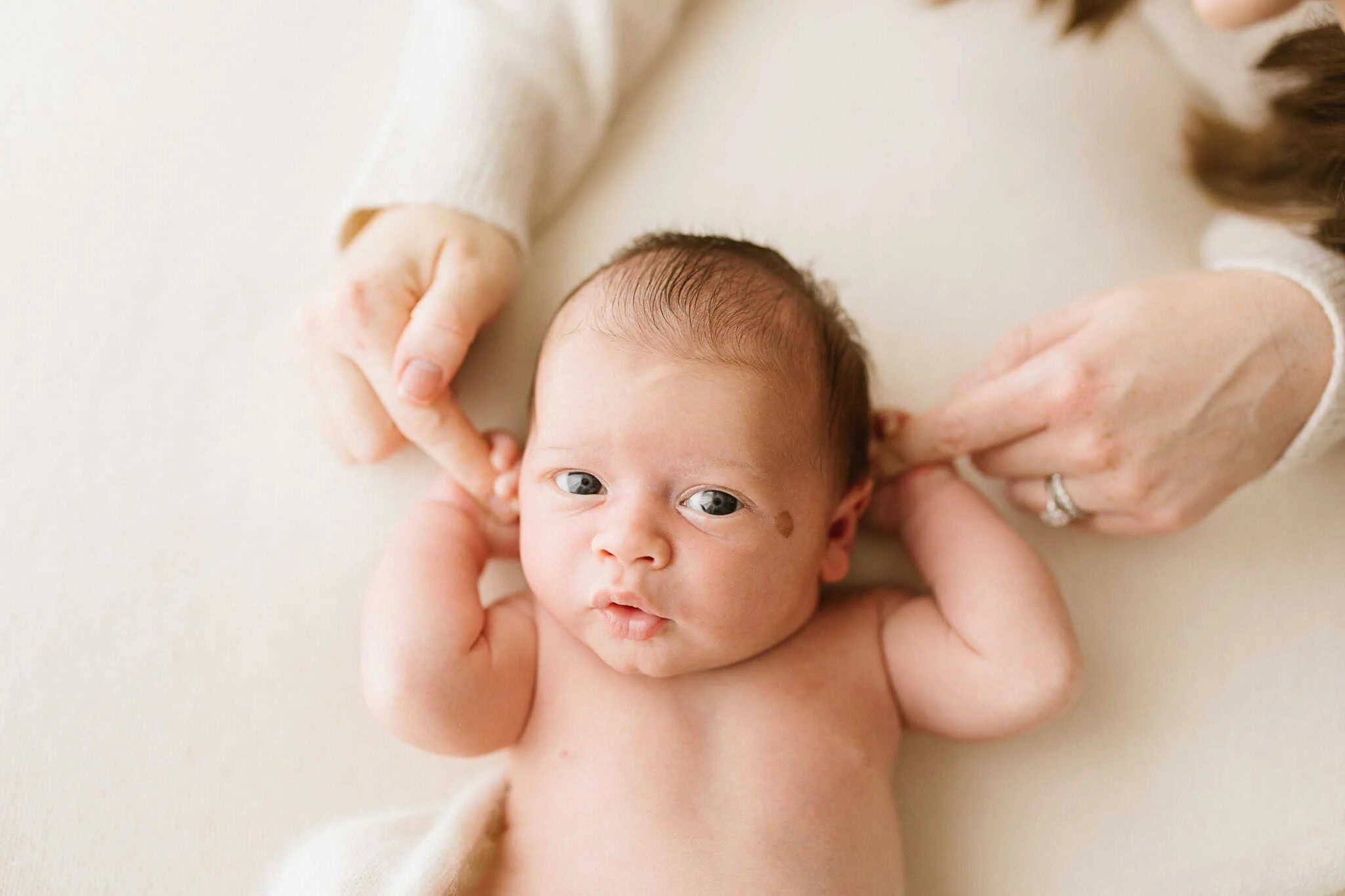 3 week old newborn baby awake and alert during newborn photography session in Cornwall